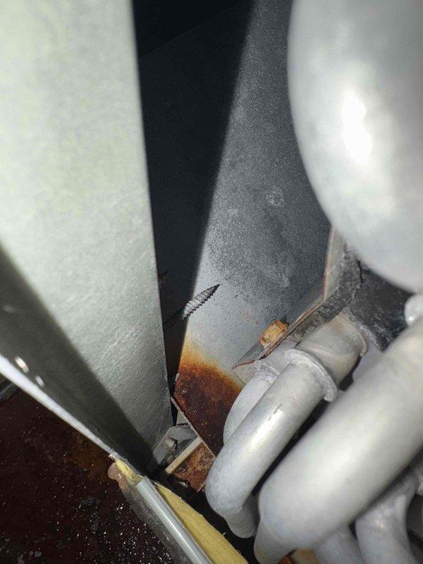 Responded to service call for 3rd floor air handler unit serving 2nd floor with reported standing water in drain pan. Upon inspection, found drain pan containing water with significant rust corrosion throughout pan and surrounding components. Observed heavy rust staining on fasteners and metal surfaces, along with deteriorated and soiled insulation materials within unit cabinet showing extensive dirt accumulation and degradation. Documented conditions with photographs showing extent of corrosion, water damage, and insulation deterioration for further assessment and repair recommendations.