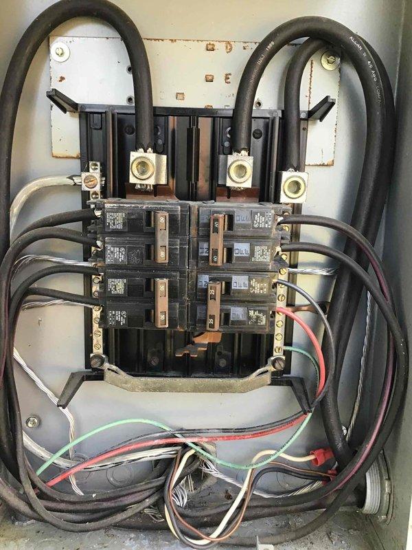 Completed comprehensive 32-point electrical system evaluation on 1990 residential property. Performed electrical panel maintenance including proper torquing of all connections and visual inspection of breaker box components, noting some rust staining on mounting plate and aged wiring configuration. Conducted GFCI/shock protection outlet and breaker testing, arc fault/fire protection breaker testing, and smoke and CO2 detector maintenance with battery replacement to ensure all safety systems functioning properly. Replaced customer-supplied light bulbs in fixtures up to 12 feet and cleaned ceiling fans. Inspected exterior electrical panel, meter box, and associated conduit connections. All safety devices tested and verified operational.