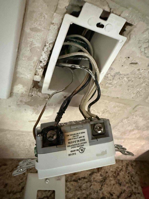 Responded to a loss of power affecting multiple outlets in a single room following a tripped breaker incident caused by an air fryer. Upon arrival, verified that all breakers were in the reset position but outlets remained de-energized while other circuits, lighting, and major appliances operated normally. Investigated the electrical panel and affected outlet circuits, identifying a failed GFCI receptacle or line-side connection issue preventing power distribution to downstream outlets. Accessed and inspected the electrical components, including terminal connections and wiring integrity, documented the installation with photographs, and restored power to all affected receptacles in the room.