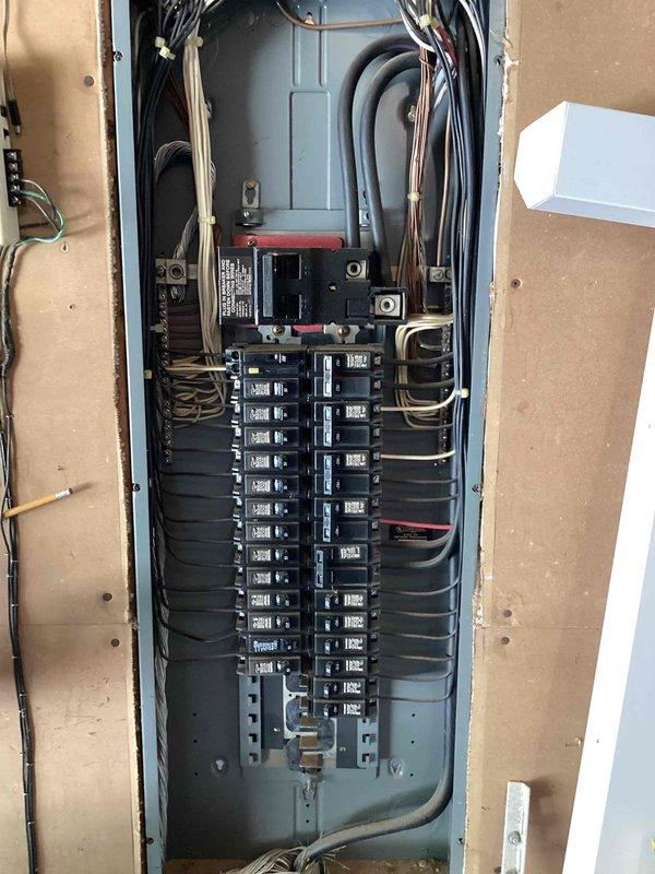 Responded to service call for chirping smoke alarm and non-functioning outlets at 1988 residential property. Upon arrival, found that breakers had been cycled by occupant in attempt to resolve smoke alarm issue, resulting in two outlets losing power. Inspected main electrical panel and all branch circuit breakers for proper operation and secure connections. Reset affected breakers and verified power restoration to outlets. Tested smoke detectors throughout home and confirmed chirping was due to end-of-life condition on multiple interconnected units. Advised that all smoke alarms are discontinued models and recommended complete replacement of all units with current code-compliant detectors to ensure proper life safety protection and eliminate nuisance alarms.