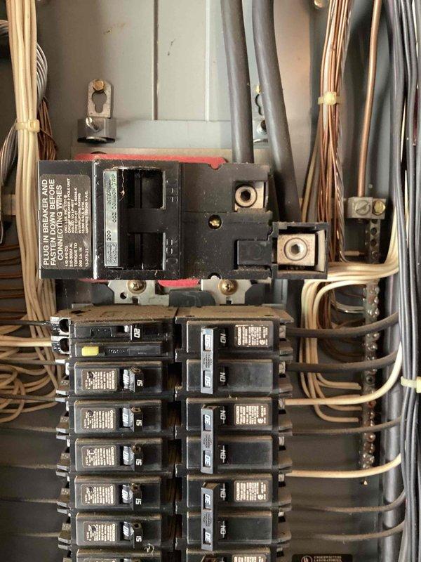 Responded to service call for chirping smoke alarm and non-functioning outlets at 1988 residential property. Upon arrival, found that breakers had been cycled by occupant in attempt to resolve smoke alarm issue, resulting in two outlets losing power. Inspected main electrical panel and all branch circuit breakers for proper operation and secure connections. Reset affected breakers and verified power restoration to outlets. Tested smoke detectors throughout home and confirmed chirping was due to end-of-life condition on multiple interconnected units. Advised that all smoke alarms are discontinued models and recommended complete replacement of all units with current code-compliant detectors to ensure proper life safety protection and eliminate nuisance alarms.