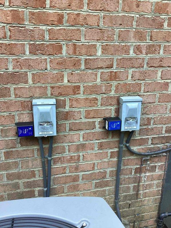 Responded to customer request for quote on additional surge protection for multiple HVAC systems. Inspected existing whole home surge protector previously installed and evaluated current electrical configuration with multiple HVAC units visible on exterior brick wall. Documented installation locations and existing surge protection equipment to provide accurate quote for three individual HVAC surge protectors as recommended by customer's HVAC contractor.