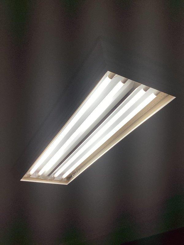 Responded to service call for fluorescent light fixture cover replacement. Customer had received new diffuser panel for existing four-lamp fluorescent fixture and requested installation. Removed old cover from ceiling-mounted fixture, verified proper fit of replacement panel, and installed new white prismatic diffuser. Tested fixture operation to ensure proper illumination and secure mounting. Service completed successfully with improved light distribution.