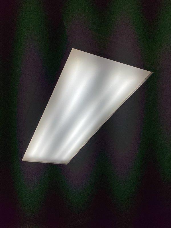 Responded to service call for fluorescent light fixture cover replacement. Customer had received new diffuser panel for existing four-lamp fluorescent fixture and requested installation. Removed old cover from ceiling-mounted fixture, verified proper fit of replacement panel, and installed new white prismatic diffuser. Tested fixture operation to ensure proper illumination and secure mounting. Service completed successfully with improved light distribution.