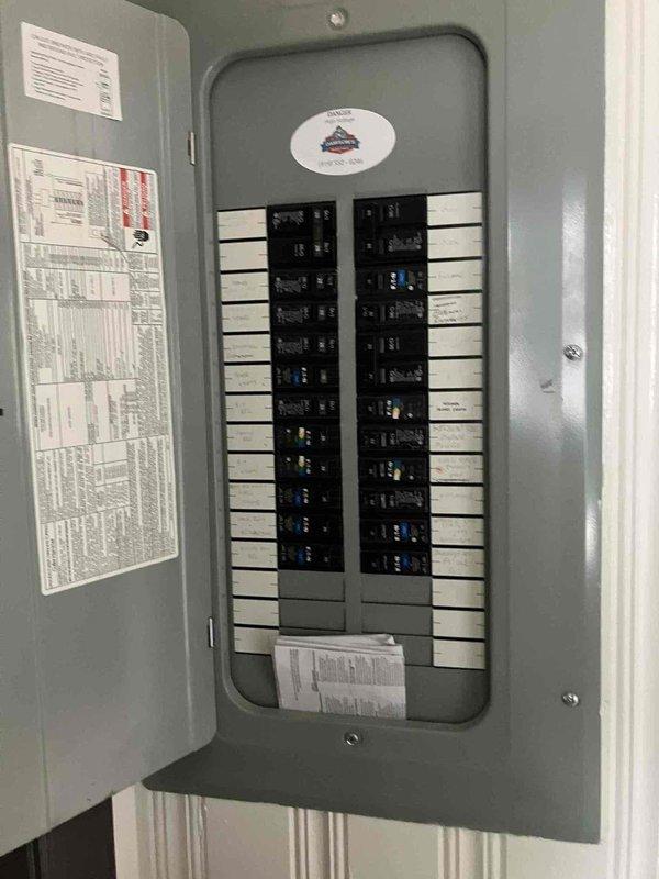 Installed new electrical outlet above fireplace in living room for wall-mounted television, running concealed wiring through interior wall from existing outlet located approximately 4 feet away to eliminate visible cords. Accessed electrical panel located on opposite side of same wall in garage, verified circuit capacity, and completed all connections per code requirements for 1959 home electrical system.