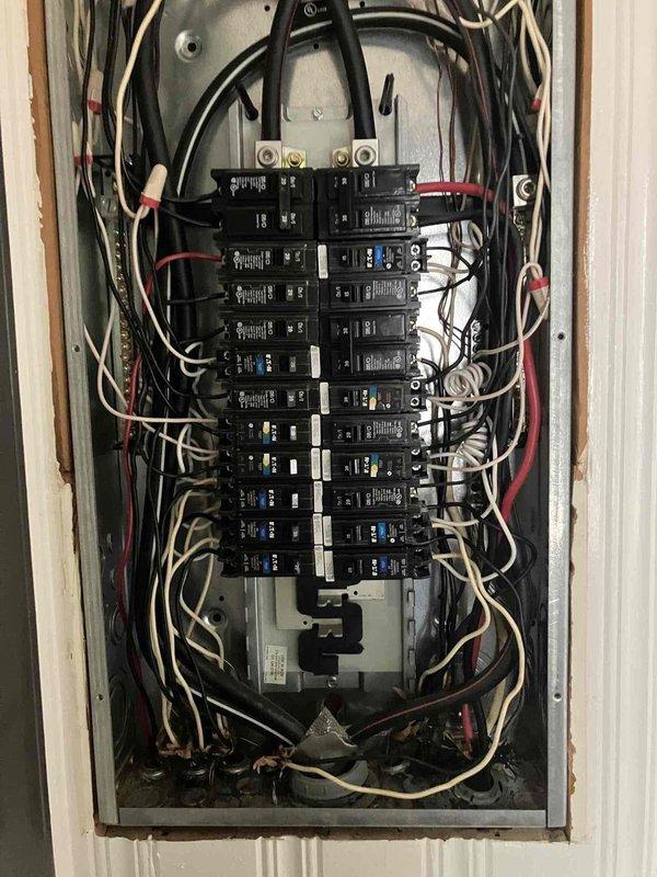 Installed new electrical outlet above fireplace in living room for wall-mounted television, running concealed wiring through interior wall from existing outlet located approximately 4 feet away to eliminate visible cords. Accessed electrical panel located on opposite side of same wall in garage, verified circuit capacity, and completed all connections per code requirements for 1959 home electrical system.