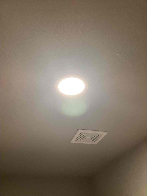 Responded to a non-functioning bathroom ceiling light in a 2023 home where the recessed LED puck light fixture had been pulled from the ceiling, exposing the junction box. Upon arrival, found the fixture disconnected and hanging loose from the electrical box. Reinstalled and secured the junction box properly to the ceiling structure, reconnected the fixture wiring to ensure correct polarity and secure connections, and remounted the recessed light assembly. Tested the wall switch operation and verified the LED light fixture was functioning correctly with no flickering or intermittent issues.