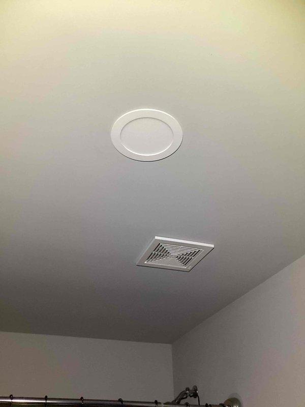 Responded to a non-functioning bathroom ceiling light in a 2023 home where the recessed LED puck light fixture had been pulled from the ceiling, exposing the junction box. Upon arrival, found the fixture disconnected and hanging loose from the electrical box. Reinstalled and secured the junction box properly to the ceiling structure, reconnected the fixture wiring to ensure correct polarity and secure connections, and remounted the recessed light assembly. Tested the wall switch operation and verified the LED light fixture was functioning correctly with no flickering or intermittent issues.