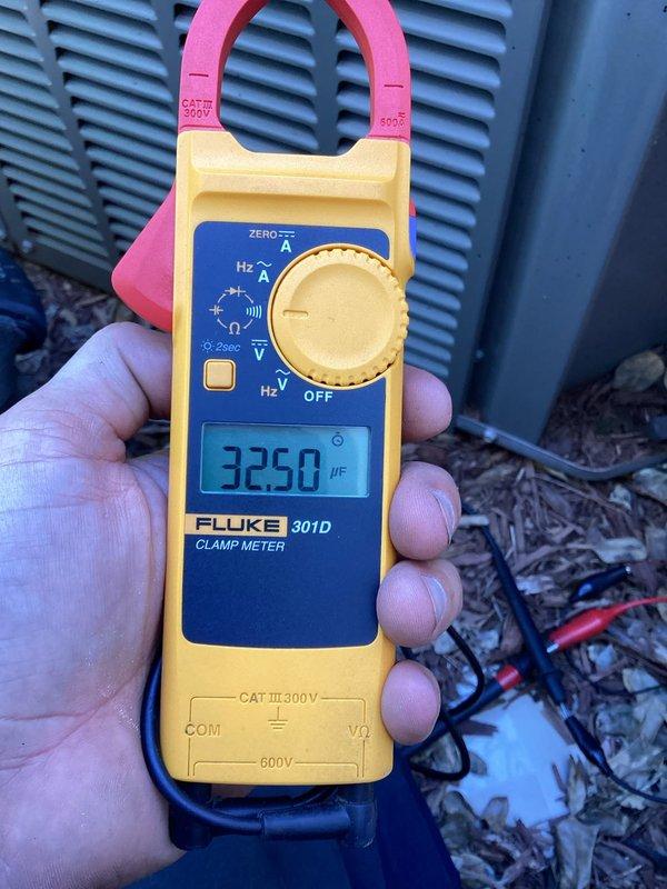 Responded to no cooling complaint on 9-year-old residential air conditioning system. Customer reported unit unable to achieve desired temperature, only reaching 74-75°F during day with no improvement at night over past several days. Upon arrival, performed diagnostic testing of outdoor condensing unit. Used clamp meter to measure electrical parameters including frequency (43.82 Hz) and capacitance (32.50 µF) at the condenser. Measurements indicated potential capacitor degradation affecting compressor performance and overall cooling capacity. Documented findings with photos of electrical readings and equipment condition for service records.