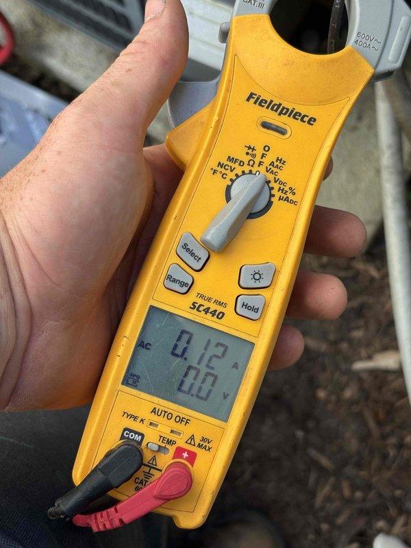 Responded to no-cooling call on 2015 HVAC system that had recently received capacitor replacement by another company but failed again shortly after. Performed diagnostic testing using clamp meter to measure electrical current and voltage at the outdoor unit, recording amperage draw of 83.5A and secondary readings of 0.2A/0.0V at different test points. Identified underlying electrical issue beyond the previously replaced capacitor and provided homeowner with detailed findings and repair options to restore system operation.