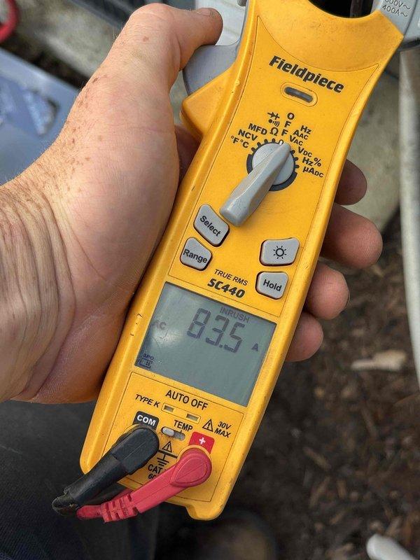 Responded to no-cooling call on 2015 HVAC system that had recently received capacitor replacement by another company but failed again shortly after. Performed diagnostic testing using clamp meter to measure electrical current and voltage at the outdoor unit, recording amperage draw of 83.5A and secondary readings of 0.2A/0.0V at different test points. Identified underlying electrical issue beyond the previously replaced capacitor and provided homeowner with detailed findings and repair options to restore system operation.
