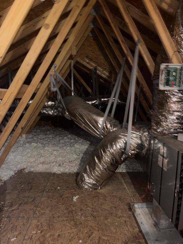 Responded to no cooling complaint at rental property with single HVAC system dating to 2012. Accessed air handler unit in attic space and performed diagnostic evaluation of system components, ductwork, and electrical connections. Inspected condensate drain pan, verified proper installation of flexible ductwork and insulation, and assessed overall system operation to identify cause of cooling failure.