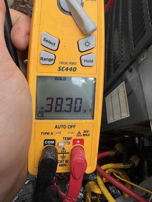 Responded to no cooling complaint on third floor system. Upon arrival, performed diagnostic testing of the HVAC equipment. Used digital multimeter to verify voltage readings at the unit, which measured 383.0 volts, indicating potential electrical supply issues. Inspected the Honeywell motorized zone damper control serving the third floor zone. Found the damper actuator displaying proper LED indicators for open/closed positions. Tested damper operation and confirmed mechanical function. Evaluated the zoning system's ability to deliver conditioned air to the third floor area. Documented equipment conditions with diagnostic readings and visual inspection of damper control mechanism and electrical connections.