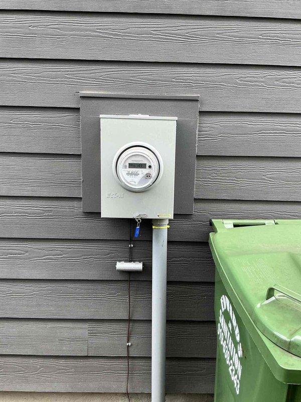 Responded to service request for bathroom exhaust fan replacement. Upon arrival, performed electrical system assessment and reviewed existing electrical panel configuration to ensure adequate circuit availability for the installation. Documented existing electrical service equipment including main panel with dual-column breaker arrangement and exterior meter assembly. Replaced defective bathroom ventilation fan with new unit, verified proper electrical connections, and tested operation to confirm functionality. All work completed in accordance with applicable electrical codes and safety standards.