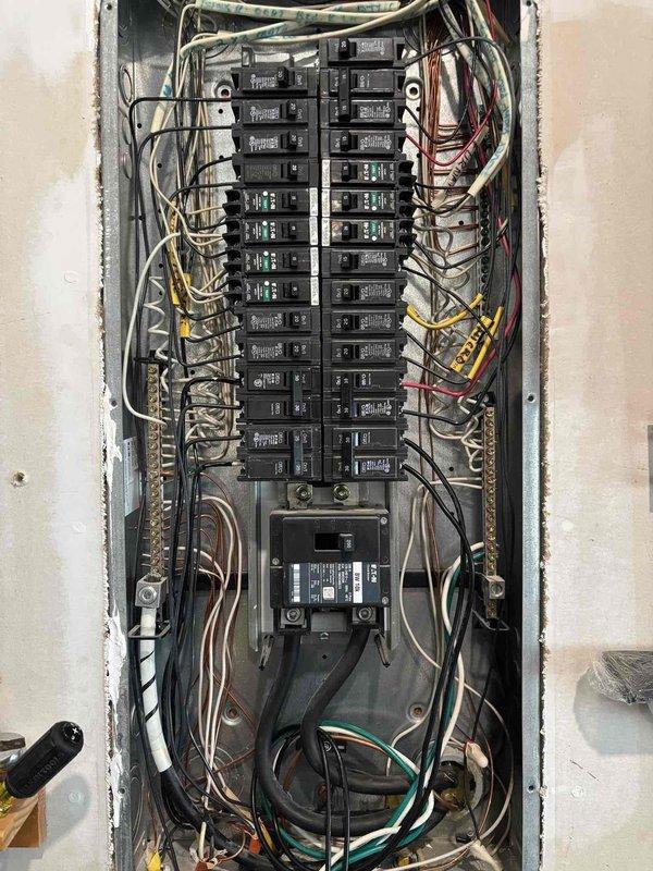 Responded to service request for bathroom exhaust fan replacement. Upon arrival, performed electrical system assessment and reviewed existing electrical panel configuration to ensure adequate circuit availability for the installation. Documented existing electrical service equipment including main panel with dual-column breaker arrangement and exterior meter assembly. Replaced defective bathroom ventilation fan with new unit, verified proper electrical connections, and tested operation to confirm functionality. All work completed in accordance with applicable electrical codes and safety standards.