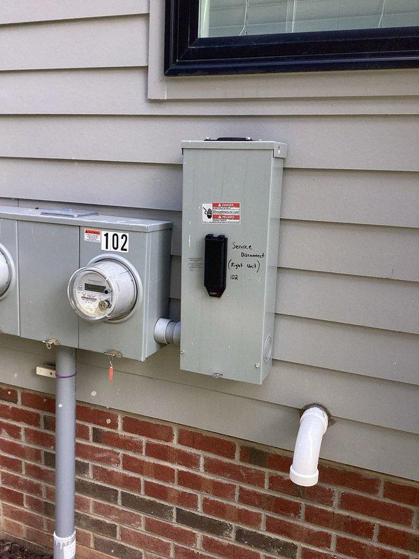 Responded to duplex unit experiencing snapping noise from outdoor outlet with breaker serving living room, internet, lights, and multiple interior outlets in tripped position. Inspected main electrical panel and exterior service disconnect, documented existing wiring configuration including main service conductors and circuit breaker arrangement. Customer advised to keep breaker off until outdoor outlet circuit can be isolated and repaired to prevent potential electrical hazard affecting multiple interior circuits.
