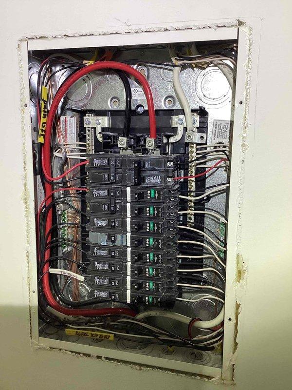 Responded to duplex unit experiencing snapping noise from outdoor outlet with breaker serving living room, internet, lights, and multiple interior outlets in tripped position. Inspected main electrical panel and exterior service disconnect, documented existing wiring configuration including main service conductors and circuit breaker arrangement. Customer advised to keep breaker off until outdoor outlet circuit can be isolated and repaired to prevent potential electrical hazard affecting multiple interior circuits.