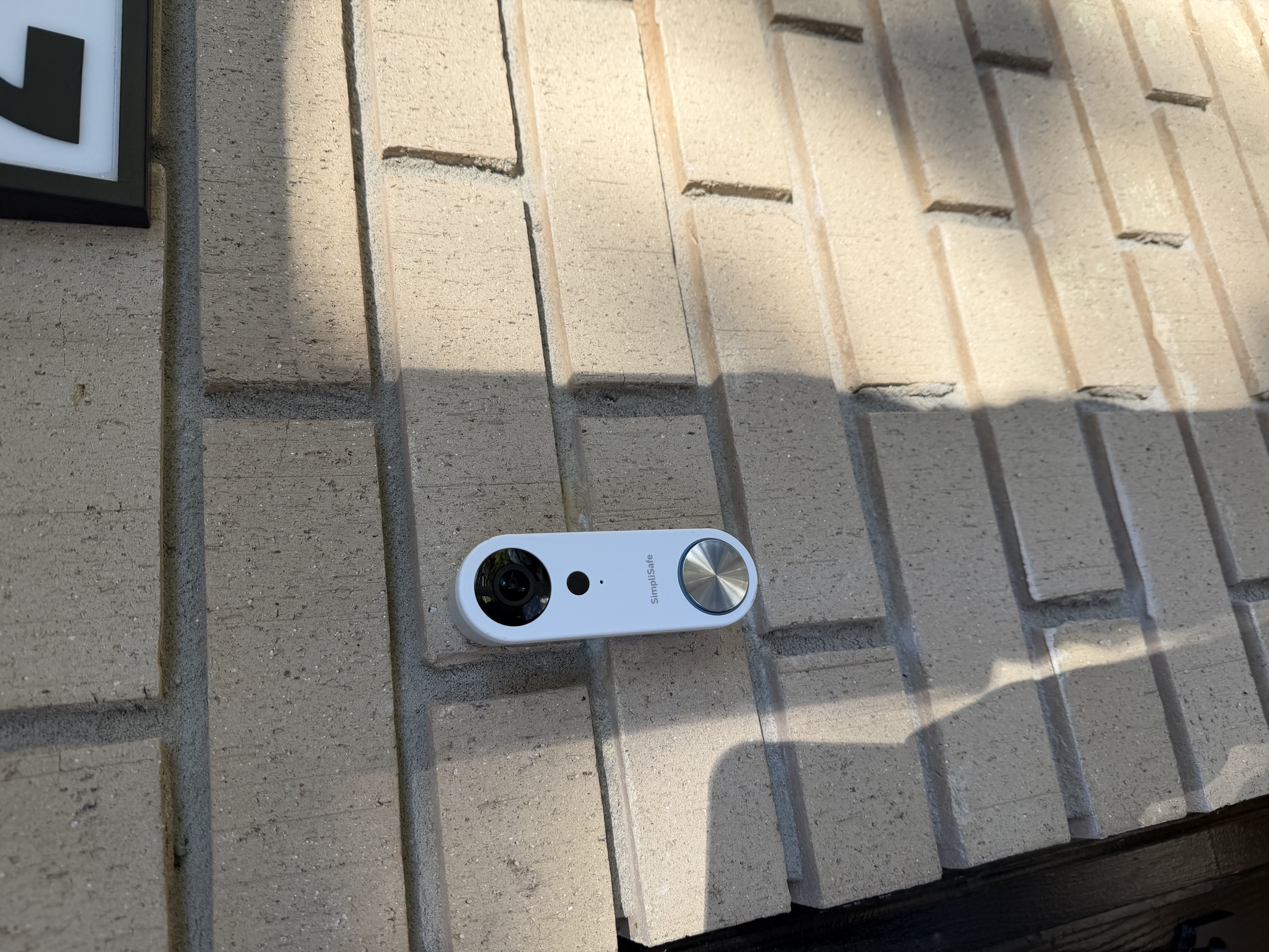 We relocated the wired doorbell, carefully disconnecting it from its original position and rewiring it to a new spot, ensuring it functions perfectly with the new storm door.