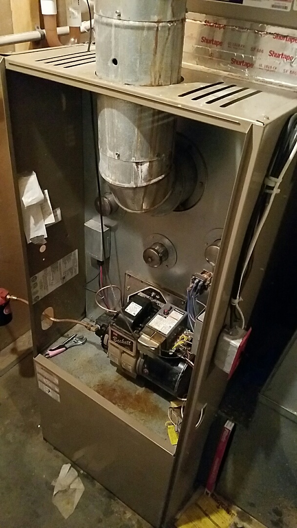 Repairing this oil fired furnace. Not a clean job, but somebody has to do it.