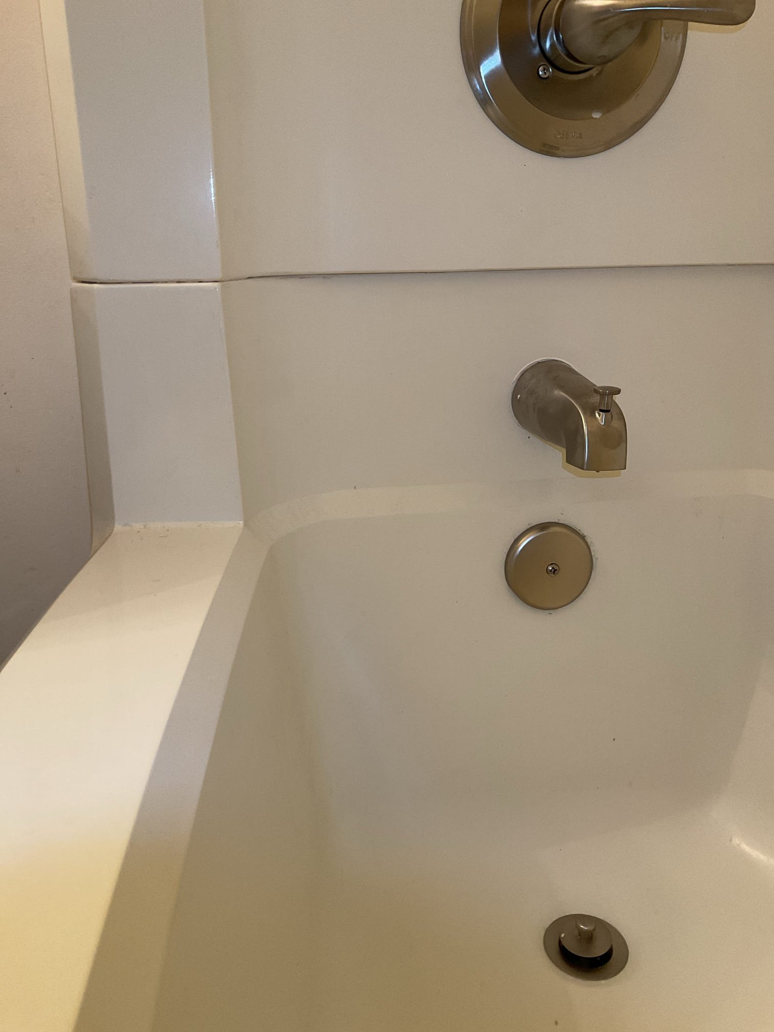 -Upon arrival the technicians removed both toilets and water supply lines. The water to the unit had to be turned off to complete the scope of work. There was one gate valve in the ceiling assembly above the water heater. This gate valve turns the water off to the clothes washer valve and kitchen. It also turns the water off to the water heater and kitchen in the unit above. After discovering that the water to the bathrooms in the unit were still under pressure the technicians turned the water off to the whole building and installed two ball valves. One for the hot water in the bathrooms and one for the cold in both bathrooms. After completing this techs were able to remove both vanities, replace 2 toilet shutoffs with compression stops, and remove existing shower. 

-Second day techs removed the existing tub drain. The drain was plumbed with 1 1/2" copper and 2" cast iron. The copper was removed from the cast iron ptrap. A rubber bushing was used to adapt from the cast iron to pvc. Mo