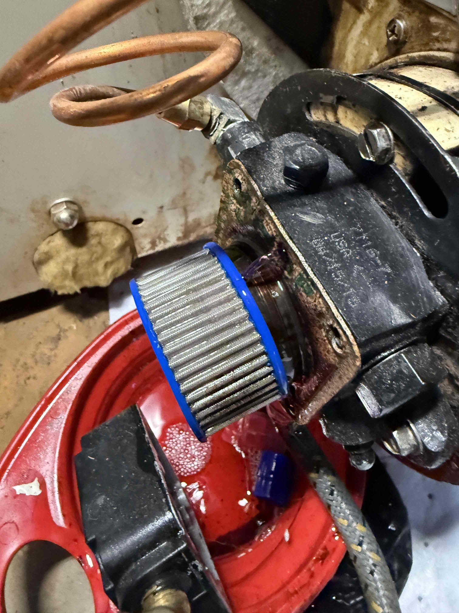 Performed annual maintenance on the oil-fired boiler, including replacement of the nozzle, oil filter, and pump strainer. The boiler was heavily sooted; all heat exchanger surfaces were thoroughly brushed and vacuumed.

During inspection, it was found that the boiler sections are leaking combustion products. This indicates that the boiler has failed and is no longer safe for operation. The unit was red-tagged and disabled for safety reasons.

Estimates for boiler replacement will be provided via email as soon as possible.
