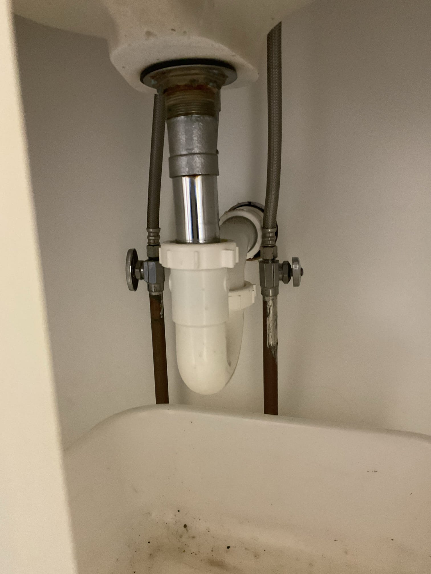 Removed the old lavatory faucet, which had been leaking due to overall wear and age. Installed a new chrome Delta two-handle faucet with a matching chrome pop-up assembly. Replaced both supply lines from the shut-off valves to the faucet. Installed a new nut and gasket on the P-trap. Tested the faucet and drain for proper operation — no leaks were found.
