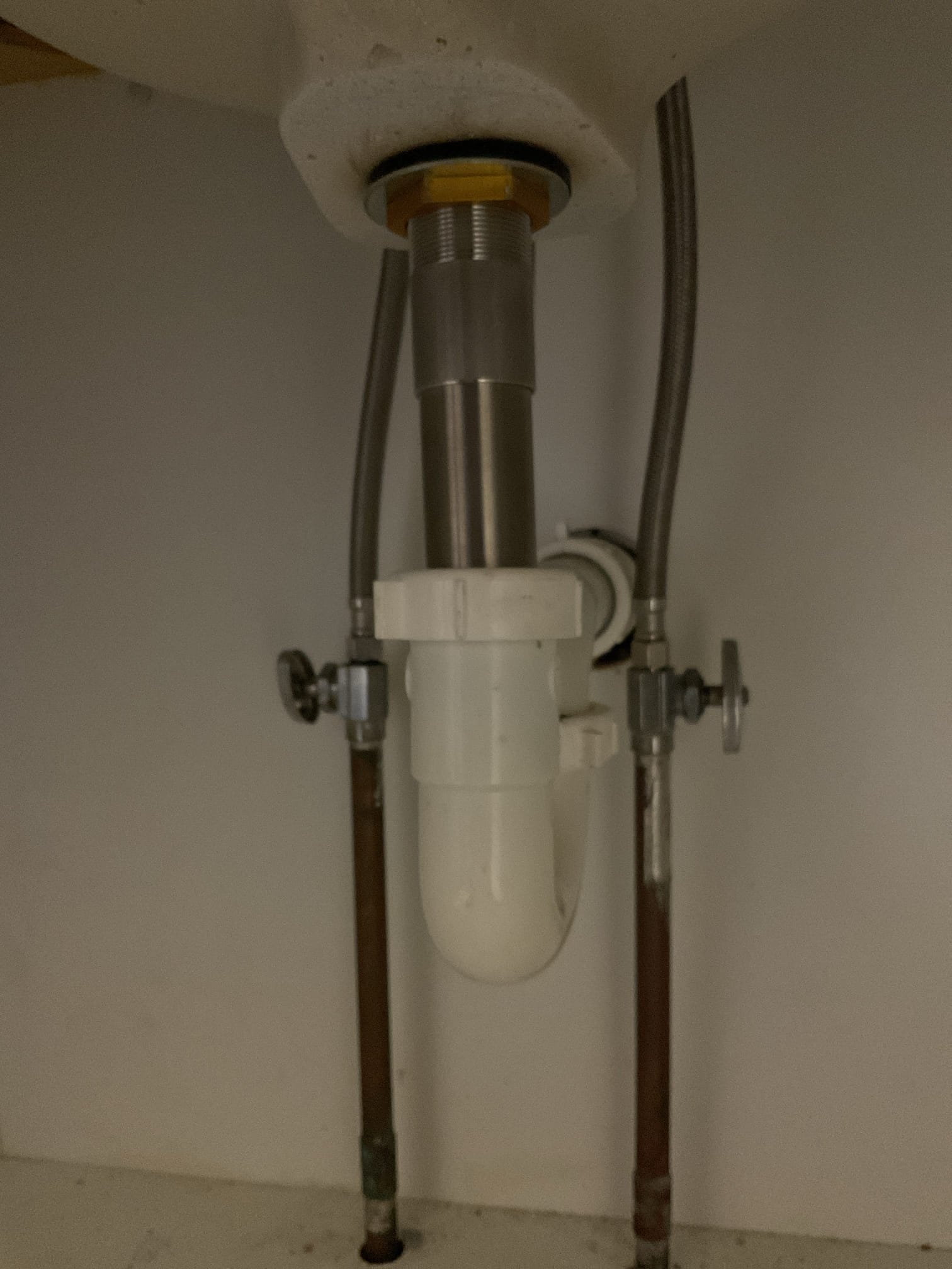 Removed the old lavatory faucet, which had been leaking due to overall wear and age. Installed a new chrome Delta two-handle faucet with a matching chrome pop-up assembly. Replaced both supply lines from the shut-off valves to the faucet. Installed a new nut and gasket on the P-trap. Tested the faucet and drain for proper operation — no leaks were found.
