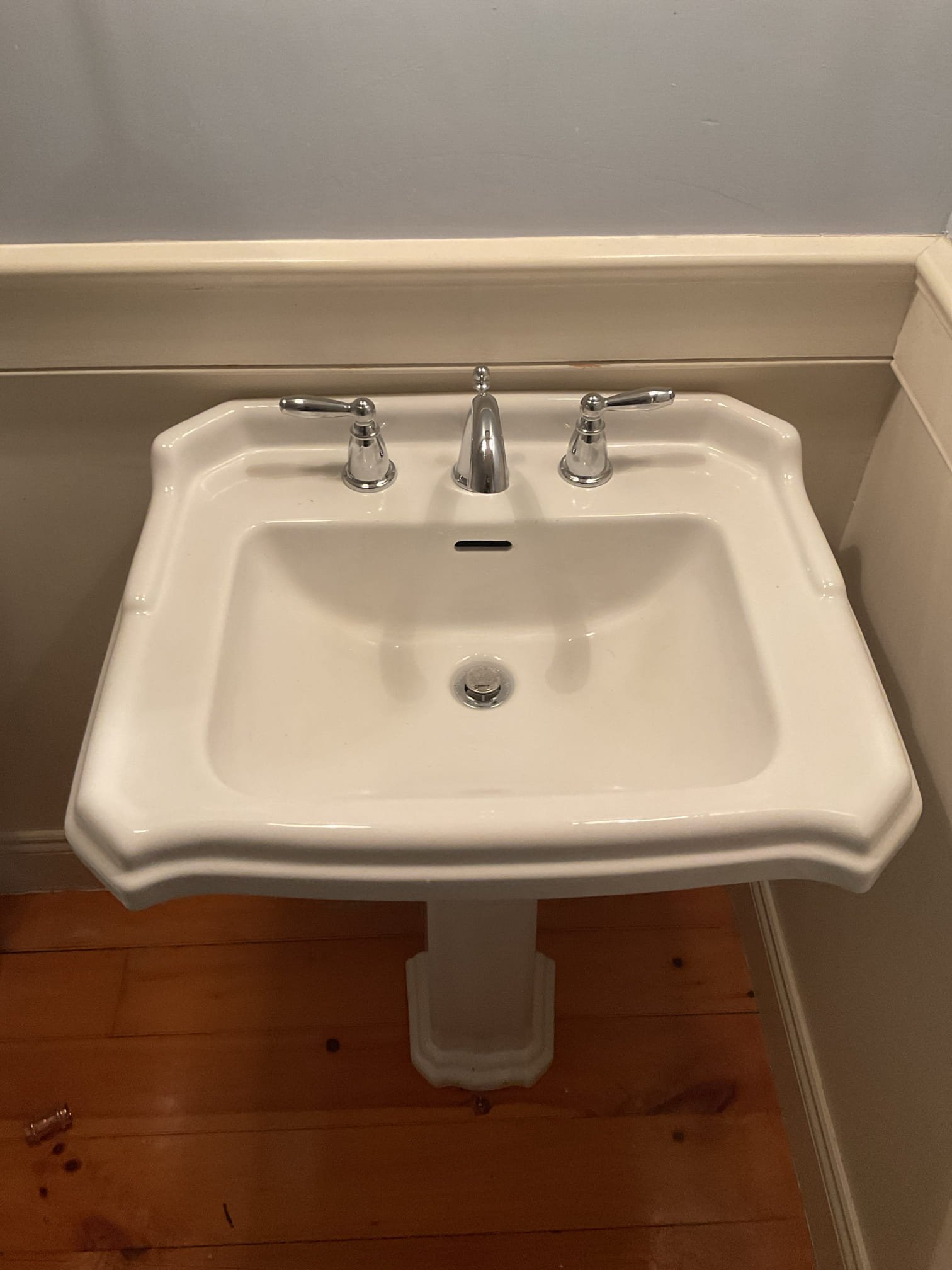 -Upon inspection, the existing shutoff valves were found to be worn and not functioning properly, posing a potential risk of leaks or water damage. The valves were replaced, and the customer-supplied faucet was installed to ensure reliable operation and improved water control.

Scope of Work:
-Disconnected water and drainage connections and carefully removed the pedestal sink from the wall.
-Removed the existing faucet, drain assembly, and pop-up mechanism. With the water supply off, unsoldered and removed the existing shutoff valves.
-During water isolation, the hot water shutoff valve for the water heater began leaking from the valve body/core. This valve was replaced with a new quarter-turn ProPress valve.
-Cleaned all related surfaces thoroughly, including the pedestal, sink bowl, copper piping, and adjacent wall areas.
-Installed new compression-style quarter-turn shutoff valves with cover sleeves and bell escutcheons.
-Restored water service and performed a full leak test — no le