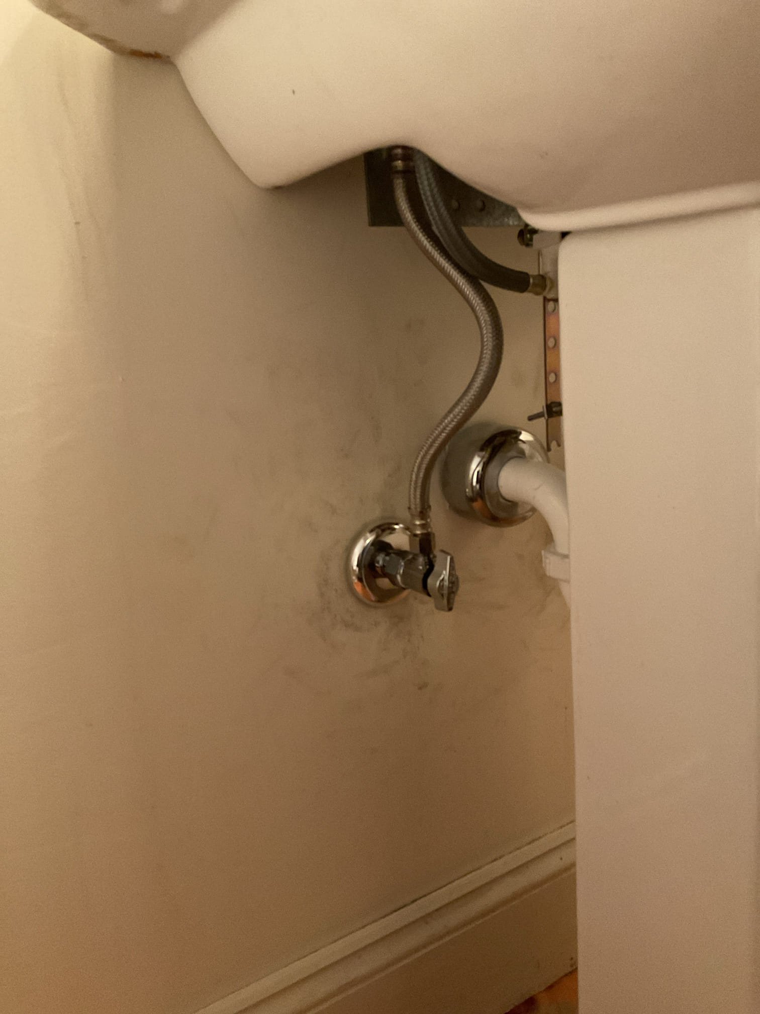 -Upon inspection, the existing shutoff valves were found to be worn and not functioning properly, posing a potential risk of leaks or water damage. The valves were replaced, and the customer-supplied faucet was installed to ensure reliable operation and improved water control.

Scope of Work:
-Disconnected water and drainage connections and carefully removed the pedestal sink from the wall.
-Removed the existing faucet, drain assembly, and pop-up mechanism. With the water supply off, unsoldered and removed the existing shutoff valves.
-During water isolation, the hot water shutoff valve for the water heater began leaking from the valve body/core. This valve was replaced with a new quarter-turn ProPress valve.
-Cleaned all related surfaces thoroughly, including the pedestal, sink bowl, copper piping, and adjacent wall areas.
-Installed new compression-style quarter-turn shutoff valves with cover sleeves and bell escutcheons.
-Restored water service and performed a full leak test — no le