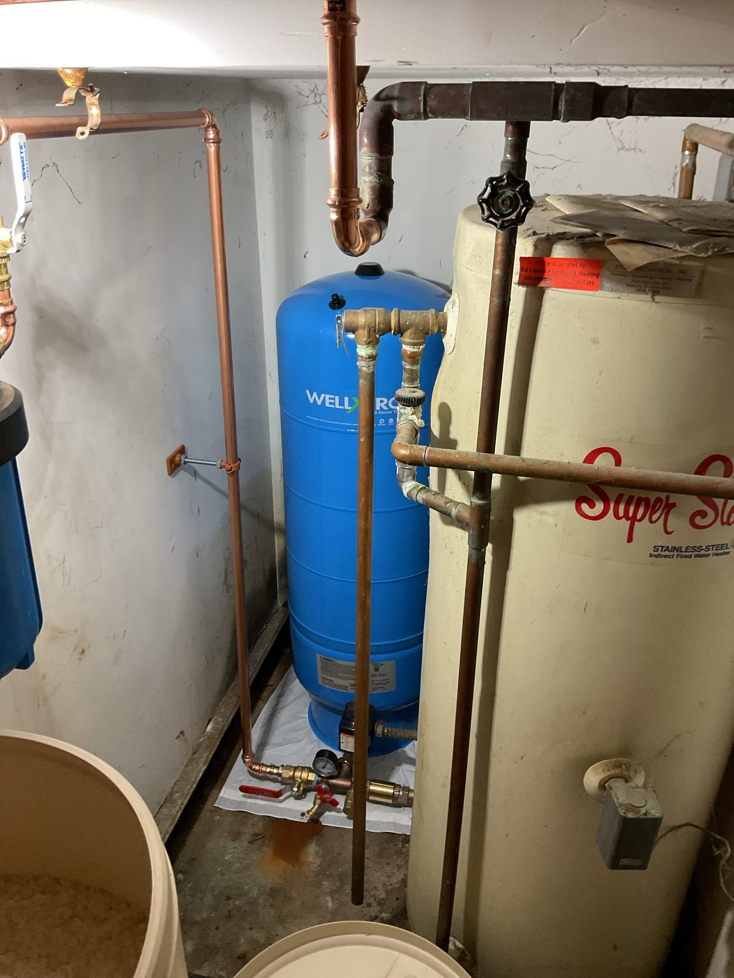 -Upon arrival tech removed and disposed of old rusted out pressure tank, water softener, and all plumbing pertaining to softener and pressure tank. 

-Tech installed new pressure tank with tank tee and pressure switch. Tech then plumbed in new softener and relocated it along back wall of the closet, replumbed sediment filter with new three-way bypass, and moved backwash line through the ceiling of the kitchen and bathroom, into the wall of the laundry room, and into laundry room. Tech then installed new backwash drain with an air gap, air admittance valve, trap, and check valve. 

-Tech then set system up and tested all fittings. Everything working well with now leaks present at time of service. 