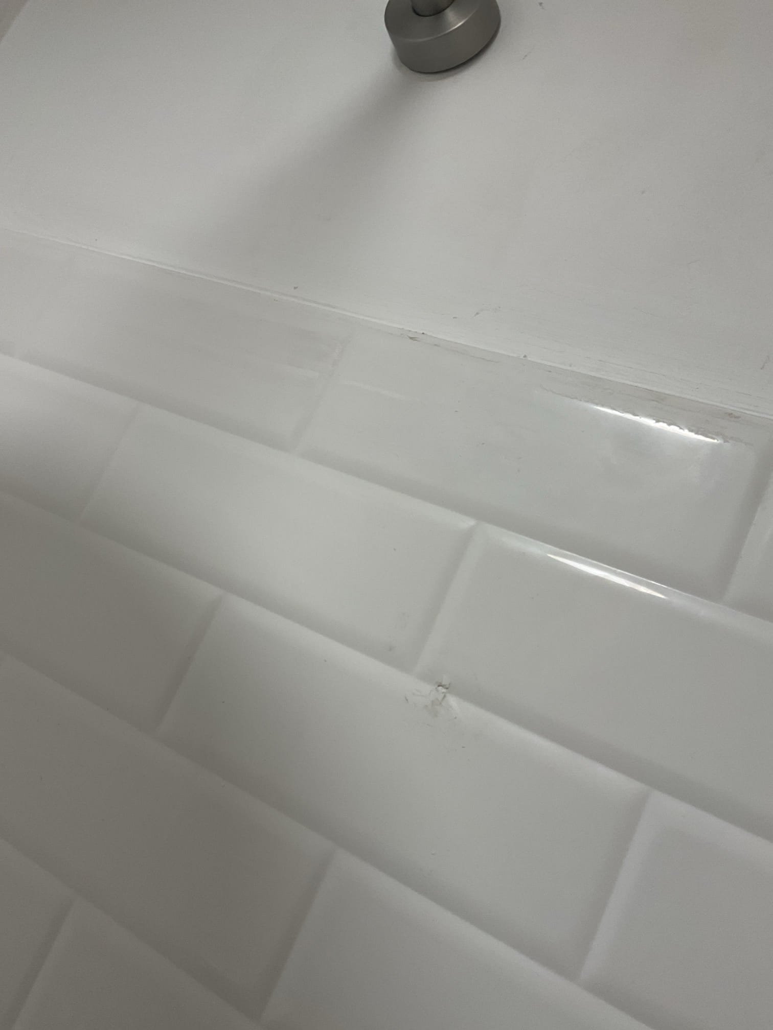 Removed the existing shower valve and installed a new homeowner-supplied 3-way shower valve with rain head, side sprayer, and tub spout. Added necessary blocking to securely support the valve, sprayer, shower head, and tub spout, ensuring solid and reliable operation.

Per homeowner request, the old shower bar was removed after advising that removal would leave two visible screw holes. The homeowner chose to have the holes filled with silicone only.

Noted that the previous plumber had drilled two holes for the tub spout and left a large gap filled with silicone. Assisted the homeowner in selecting a suitable tub spout finish ring to cover the exposed area (as shown in photos). The homeowner has ordered the part and will install it upon arrival.

