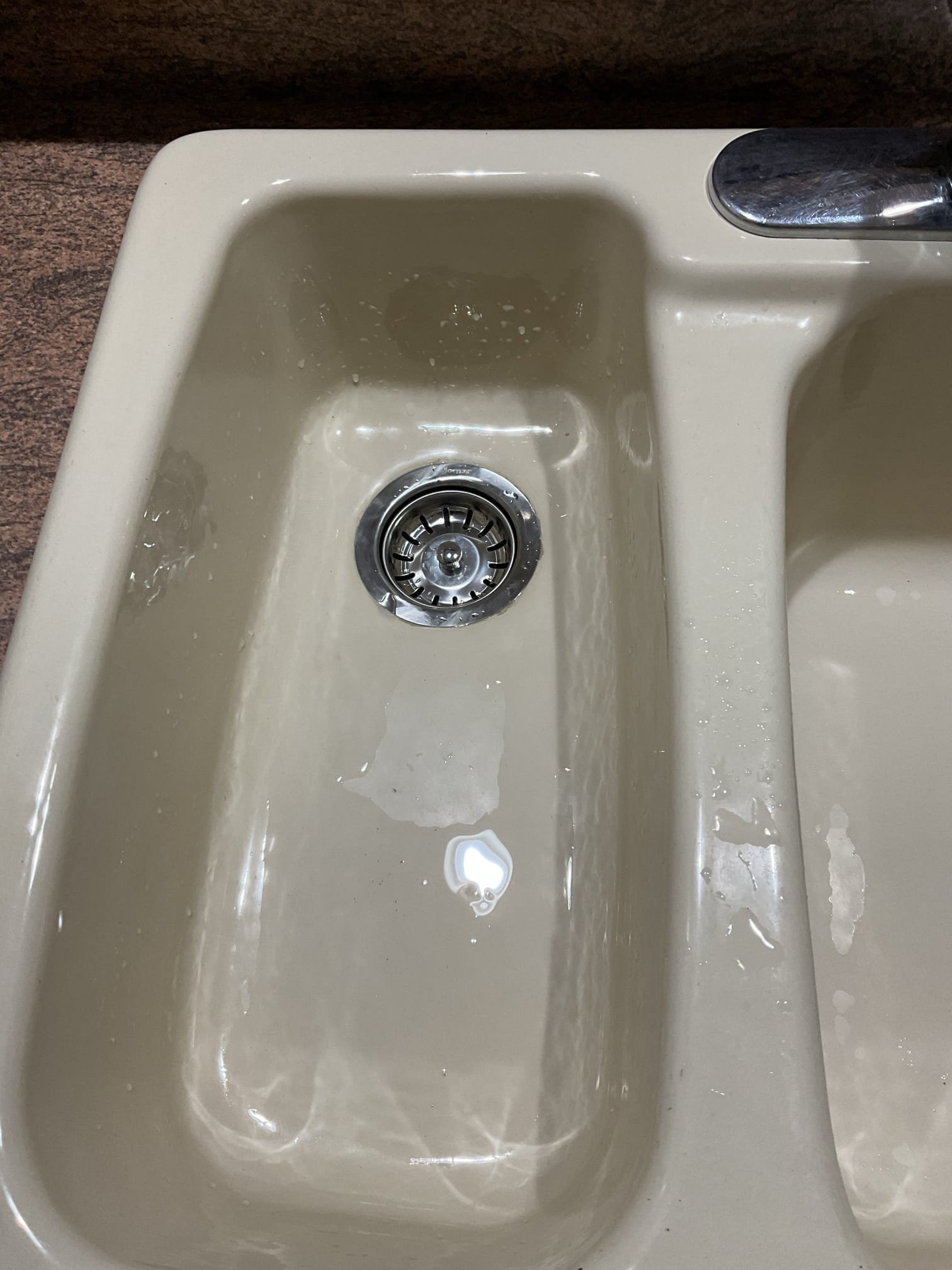 Findings:
The left-side basket strainer and tailpieces were corroded, and the existing drain piping exhibited improper pitch, which could lead to drainage issues and potential leaks.

Recommendations:
We recommended replacing the corroded components and correcting the pipe pitch to ensure proper drainage and prevent future leaks.

Work Performed:
All existing tubular drainage components, including the P-trap, tee fitting, tailpieces, and basket strainer, were removed. All connection surfaces were cleaned thoroughly. A new basket strainer was installed using plumber’s putty and securely tightened. New tailpieces, a tee fitting, a tubular connection from the garbage disposal, a tailpiece extension, and a P-trap were installed using thread sealant on all gaskets and tightened securely.

Both sink basins were filled completely and drained to test for leaks. No leaks were observed at this time, and the drainage system is currently operating properly