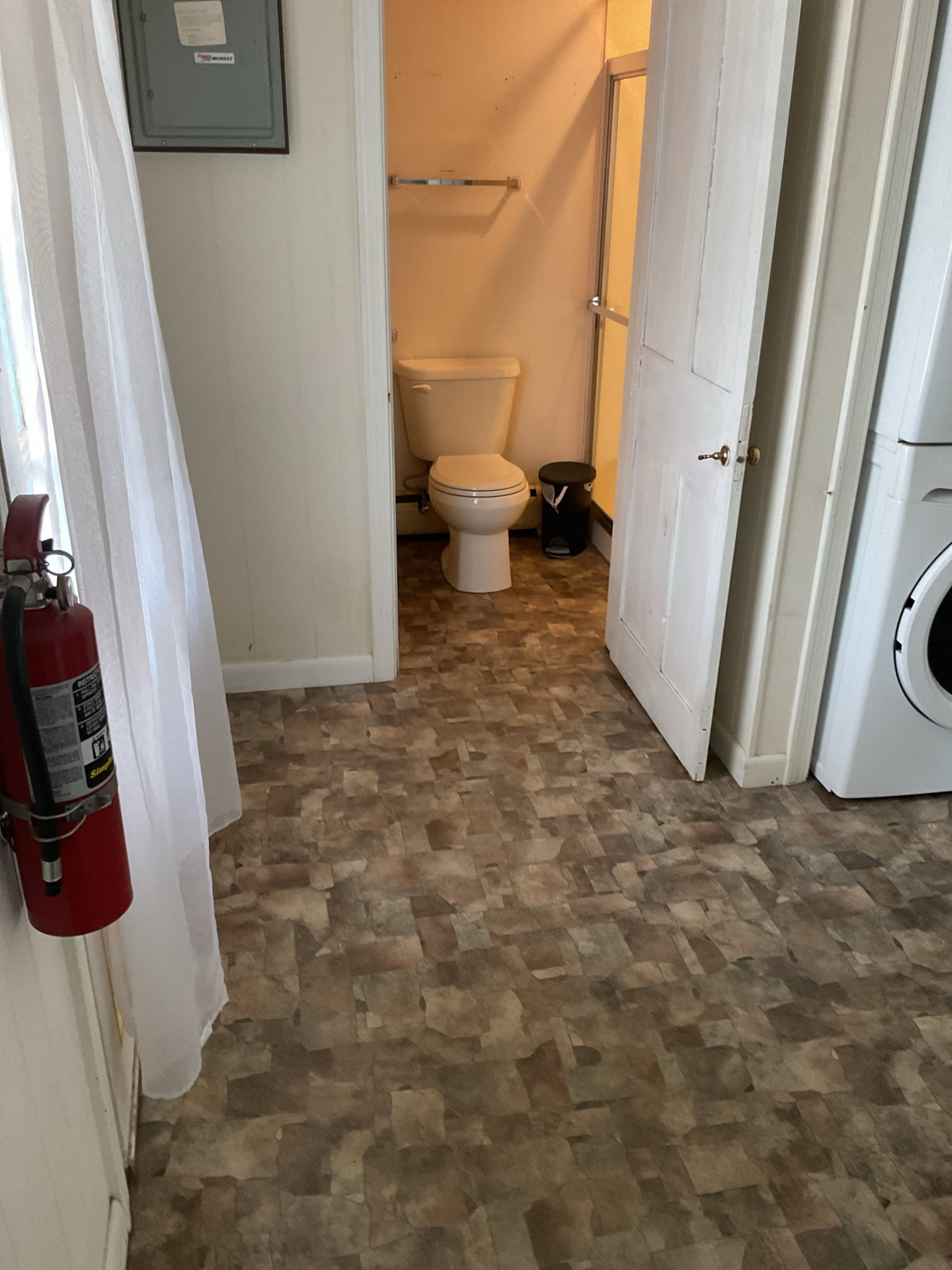 Arrived to inspect a possible plumbing leak in the main eye care area. Upon inspection, no active plumbing leaks were found in the ceiling. Flushed the toilet and ran the sink in the apartment directly above, with no leaks observed. Above the stained ceiling tile, there is a 3/4” copper 90 fitting that is very corroded that appears to be part of the baseboard heating system in the bathroom. It is likely that the fitting drips when the heat is turned on, though the heating system is currently off. The office will contact the customer to schedule a visit from a heating technician to inspect the baseboard loop.