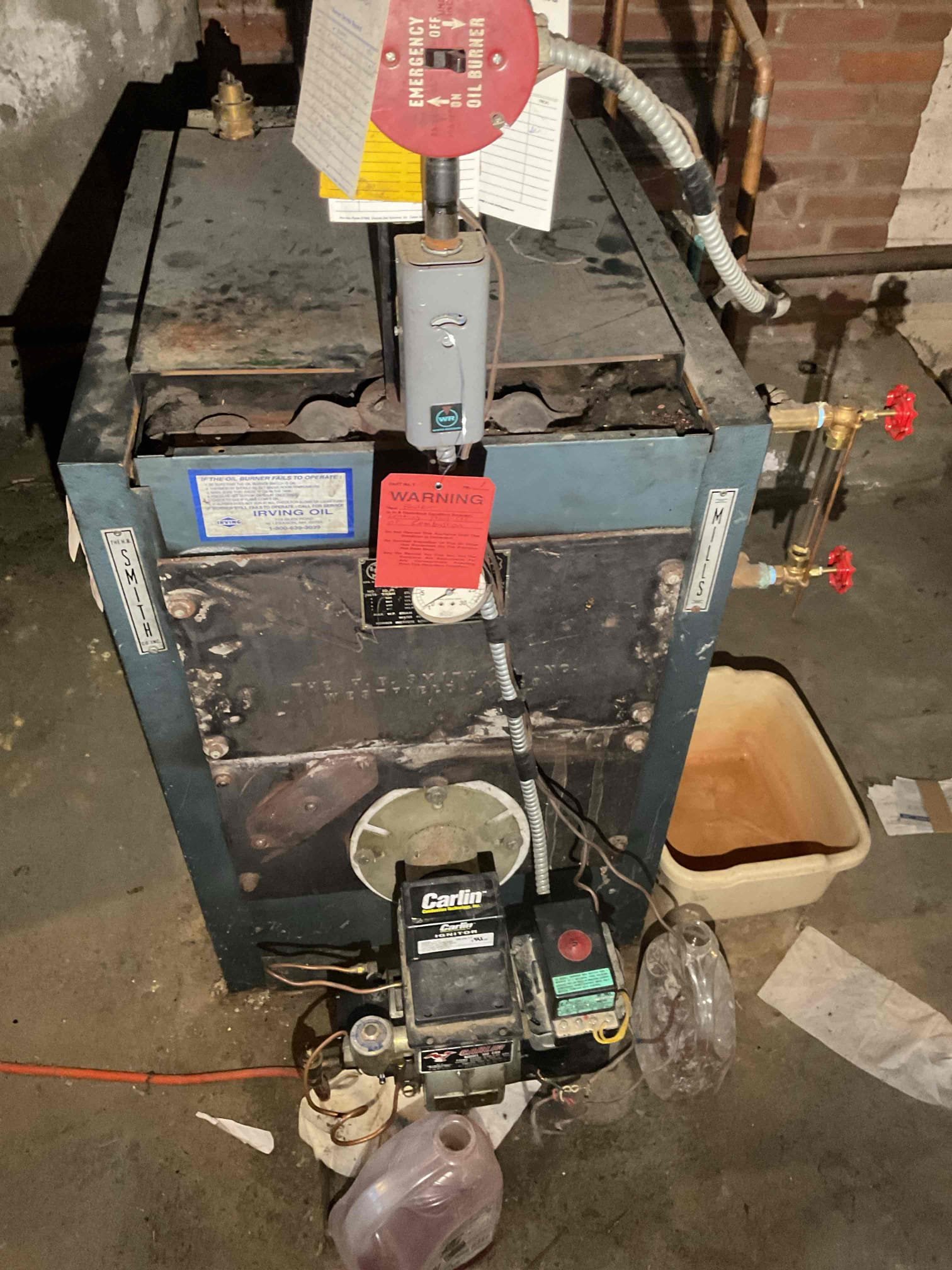 Customer reported a strong odor coming from the boiler in the main living area. Upon inspection, I observed significant soot accumulation on the top of the boiler and on the surrounding floor. Further examination through the barometric damper revealed that the smoke pipe was completely obstructed.

I removed the boiler panels to inspect the internal components and found that the seals between the boiler sections have failed, allowing combustion gases to escape each time the boiler operates. The combustion chamber was also found to be completely filled with soot. I shut the cold water feed going to the domestic coil off to prevent leaks on very corroded piping.

Due to these conditions, the boiler is unsafe to operate. I have red-tagged and disabled the unit to prevent further use. 

I explained the situation in detail to the customer’s son and, upon leaving, also spoke with Rosemary to ensure she understood the issue and the safety concerns.

The boiler must remain out of service.