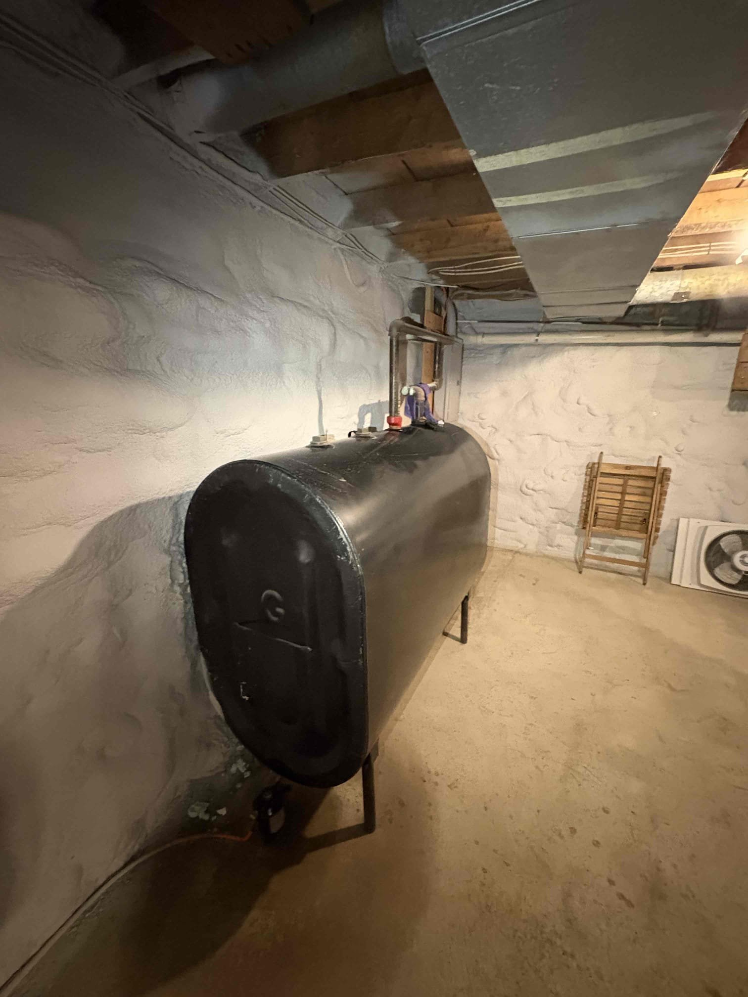 Responded to a report that the furnace blower fan would not turn on when manually activated at the thermostat. Upon inspection, found that the thermostat was wired with only a two-conductor cable, which does not support independent fan control. With approval, replaced the thermostat wire between the furnace and thermostat with a six-conductor cable. Secured the new wire along the existing Romex and fastened it to the wall for proper support. Tested operation and confirmed that the blower fan now turns on and off correctly when controlled from the thermostat and operates automatically with the burner as intended. 
Identified a minor oil leak at the oil tank filter assembly and tightened both the filter nut and bleeder nut to stop the leak. 