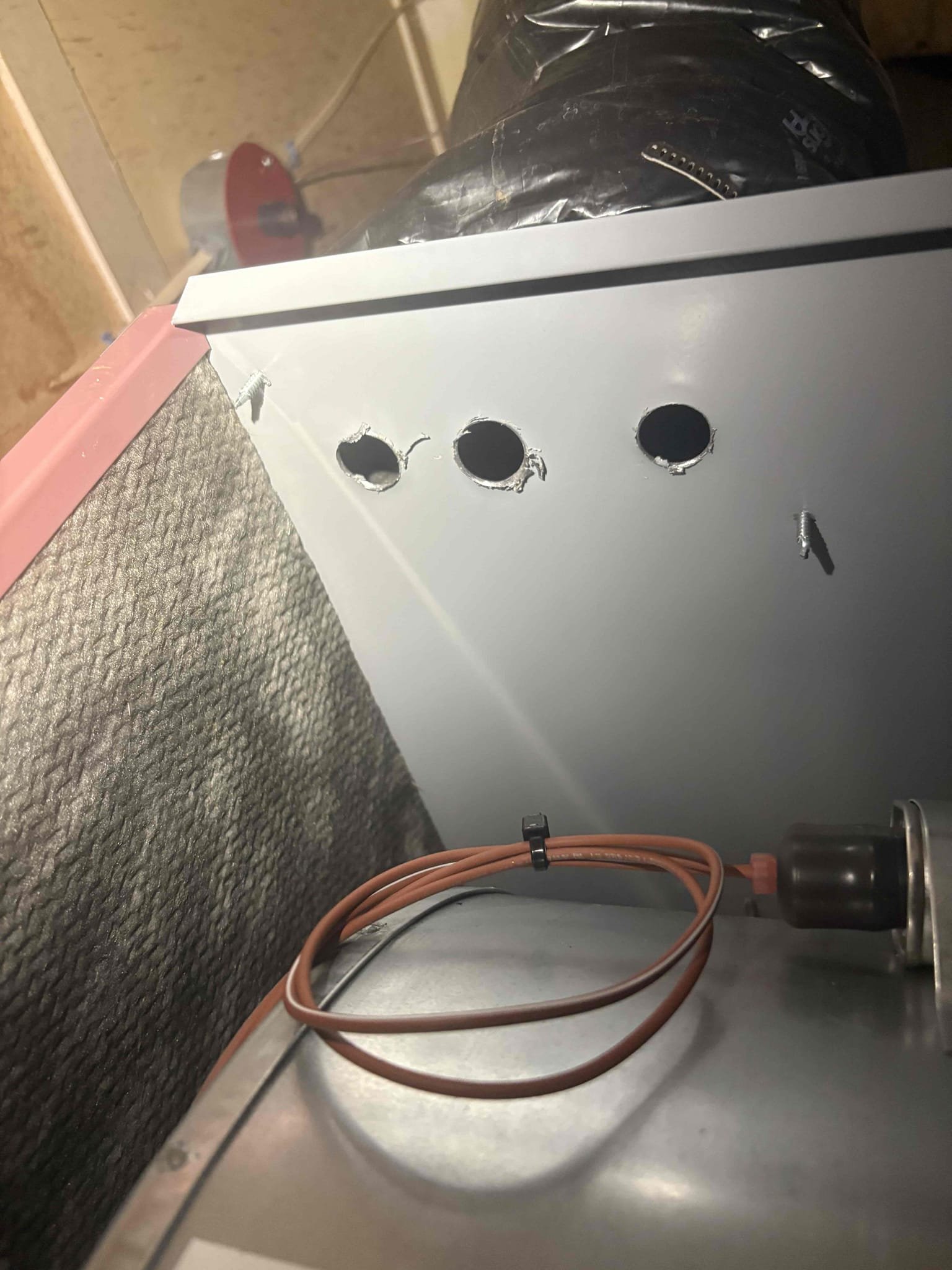 Responded to a report of a whistling noise coming from Sheryl’s recently installed Thermo Pride furnace. The homeowner reported that the noise occurred during operation, typically when the system first started, but not consistently or at any specific time of day. I began by inspecting the blower fan and burner components; all were secure, and I was unable to recreate the noise initially. I adjusted the blower fan speed and retested the system. When I partially obstructed the front face of the furnace, I was able to reproduce the whistling noise.

Upon further inspection, I found three small holes drilled in the top of the furnace for fresh air intake. When I covered one of the holes with tin tape, the noise increased in volume. I then drilled two additional larger holes in the intake and enlarged the existing ones to improve airflow. After reconnecting the air intake and running the system continuously, I was unable to recreate the whistling noise. I believe the issue was caused by the