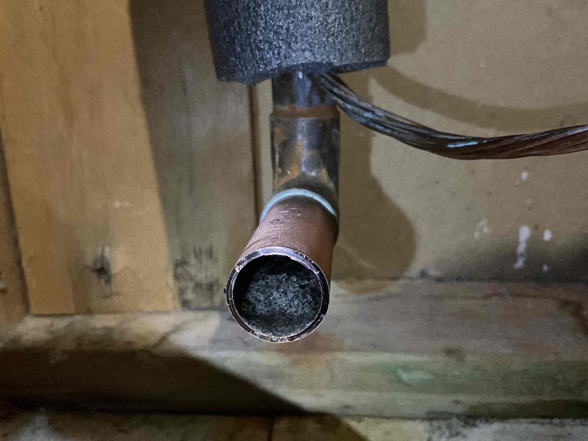 Removed the failed well tank and installed a new WX203 tank. During installation, a significant amount of sediment buildup was observed in the plumbing lines. After completing the tank installation, we installed a homeowner-supplied water filter and tested the system for proper operation. While testing, we noticed sediment quickly collecting in the kitchen sink line after removing the pull-down sprayer head.

The homeowner also pointed out sediment buildup in the tub used for draining the system. When testing the tub, the Moen 1222 shower cartridge was found to be completely packed with sediment, allowing only a minimal trickle of water. The cartridge was removed, requiring drilling and breaking due to being seized in place. Once removed, the shower wall opening was stuffed with rags, and the water was turned on to flush sediment from the lines and valve, which resulted in filling the tub with sediment as the system was cleared.

A new Moen 1222 cartridge was then installed, and the wa