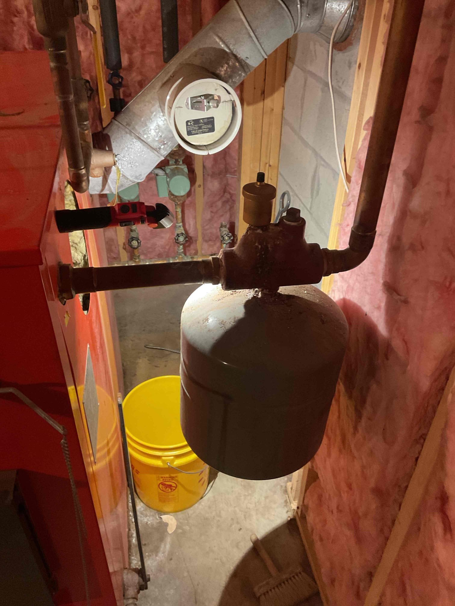 Customer reported that the relief valve on their oil/wood boiler was discharging. Upon inspection, we operated the boiler to its high limit and observed that the relief valve did not discharge during testing; however, there was evidence of prior discharge, as water was present in the bucket beneath the valve. Boiler pressure was found to be at 25 PSI.

Checked the expansion tank and determined that it has failed, leaving no room for system expansion as the boiler heats, which likely caused the relief valve to release. Presented the customer with estimates for replacement of the expansion tank and relief valve, as well as the addition of a drip leg to the relief valve outlet for safety.

We are scheduled to return in the morning to perform the recommended repairs. For the interim, the aquastat was turned down to 160°F to limit boiler temperature overnight. The customer has been advised that if the supply zone shutoff valve leaks when closed during service, an additional estimate will be