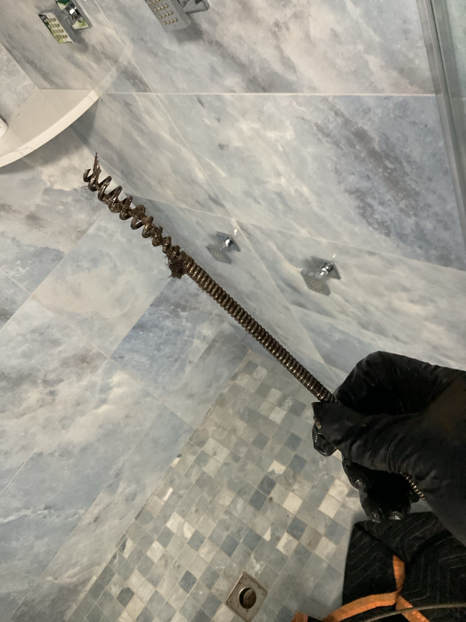 -Upon arrival customer had a shower drain that was very slow. Customer stated it had been like that for quite some time. Tech recommended snaking the drain and customer signed off on this solution. 

-Tech ran Milwaukee drain snake down drain approximately 6 feet. Tech hit some obstruction approximately 1 foot into drain. Upon retracting drain tech found a clump of hair on snake. This was most likely the reason for the clog. After snaking drain tech used a small portion of thrift drain cleaner to clean out any dislodged debris from pipe. 

-Tech ran rain head shower for approximately 15 minutes with no issues. Clog appears to be resolved

-Email invoice and collect payment