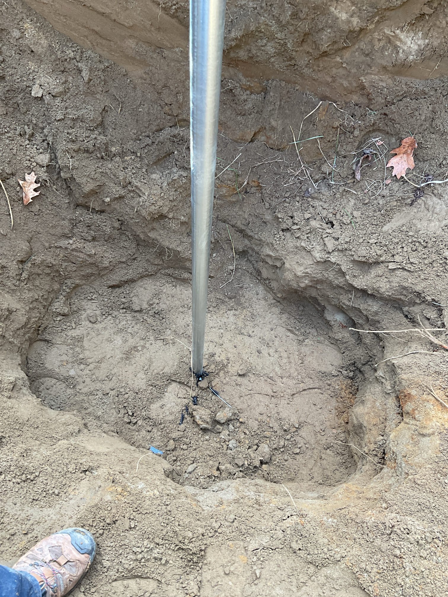 For this call, we shut off the water at the curb stop to the residence and yard hydrant and isolated the line for hydrant removal. After relocating a large rock for safety, we excavated around the existing yard hydrant to a depth of approximately five feet. The hydrant was found to be connected to a galvanized nipple embedded in a concrete slab, with no drainage stone installed around the weep hole.

We installed a new yard hydrant, connected it to the existing water line, and added proper drainage stone around the weep hole. The stone was covered with silt fabric, and the excavation was backfilled in 6-inch compacted lifts. The new hydrant was tested and is operating correctly with full pressure and no leaks at this time.

The ground was raked and leveled, and grass seed was applied; however, due to the season and temperature, germination is not expected. A bag of grass seed and a bale of hay were left with the homeowner for reseeding in the spring.