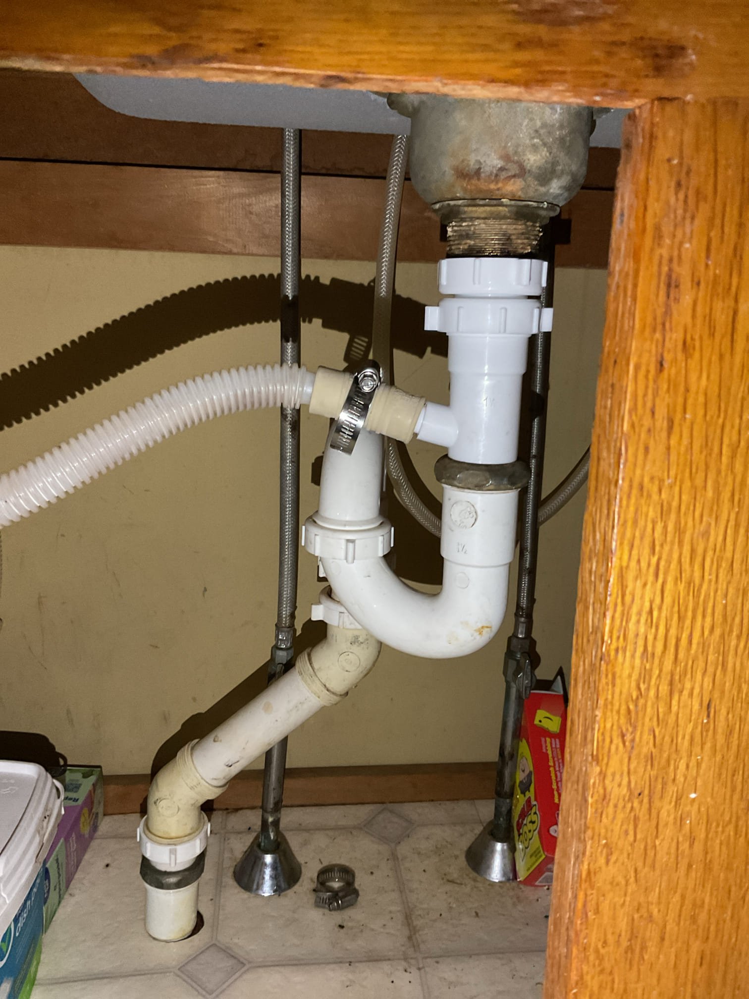 I was called to a home to fix a slow-draining kitchen sink. Upon inspection, I found that the kitchen drain was clogged and needed to be snaked. While snaking the drain, I noticed that the dishwasher tailpiece was hanging on by a thread. I also noticed that the gasket was deformed. To resolve the issue, I installed a new dishwasher tailpiece and re-assembled the drainage. After snaking and re-assembling the drainage, I tested for proper operation and drainage, and there were no leaks observed at this time.