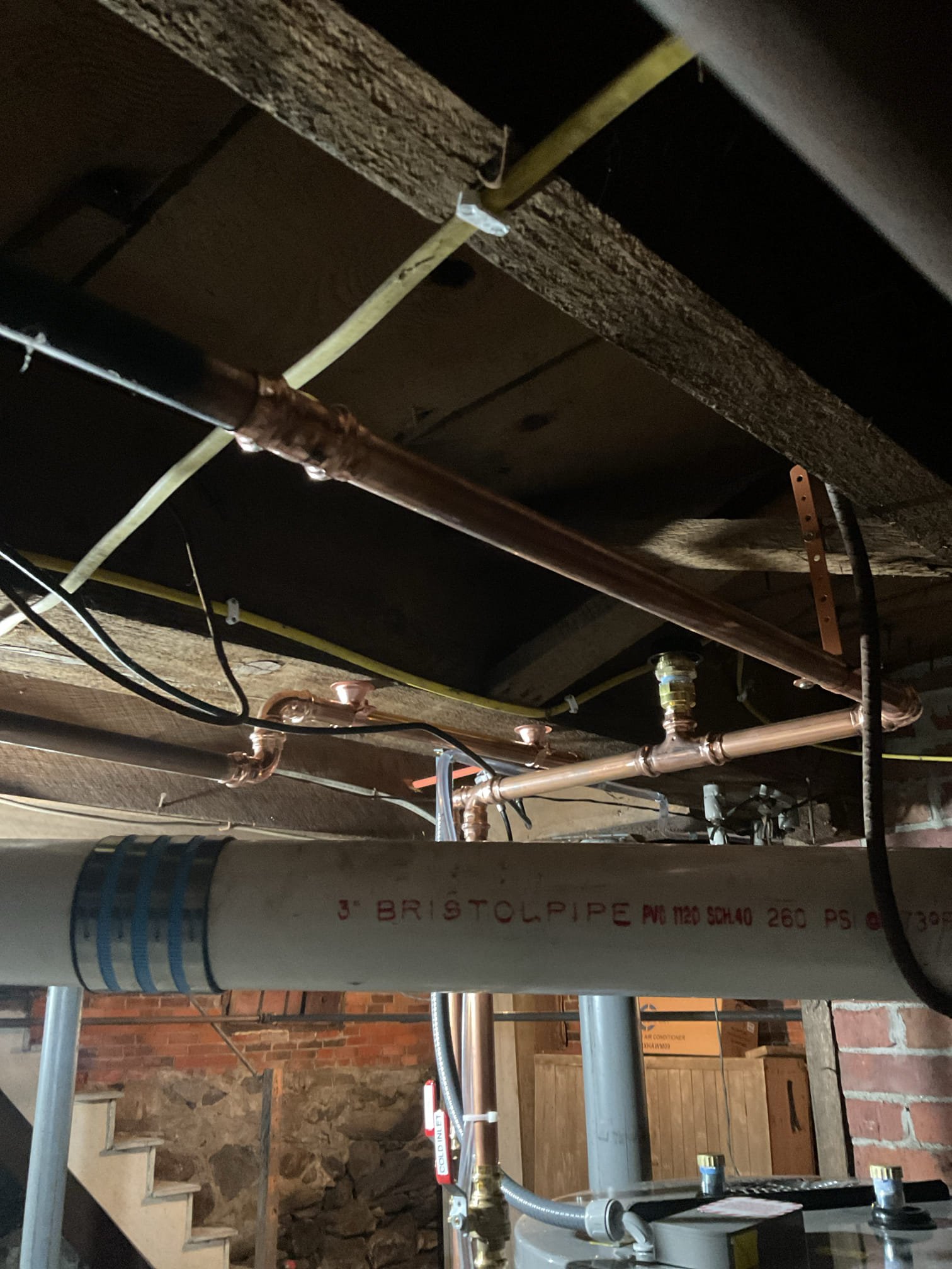 12/1
We found that the existing electric water heater had failed and was no longer supplying reliable hot water. We recommended replacing it with a new 65-gallon hybrid water heater to restore dependable performance and improve the home’s overall energy efficiency.

Upon arrival, we shut off the home’s water supply and drained the existing water heater before removing it. We reset the concrete blocks to create a level base, then set and leveled the new 65-gallon hybrid unit using shims. We installed a new mixing valve, vacuum breaker, and hot and cold shutoff valves. The electrical connection was tied into the existing circuit, upgrading the cover sleeve to liquid-tight conduit to ensure a code-compliant waterproof seal.

Both hot and cold lines were connected to the existing 3/4” copper piping, and the failed gate valve was removed. The water was turned back on and the unit was filled; once full, power was restored and the system was confirmed to be heating properly.

A new condensate