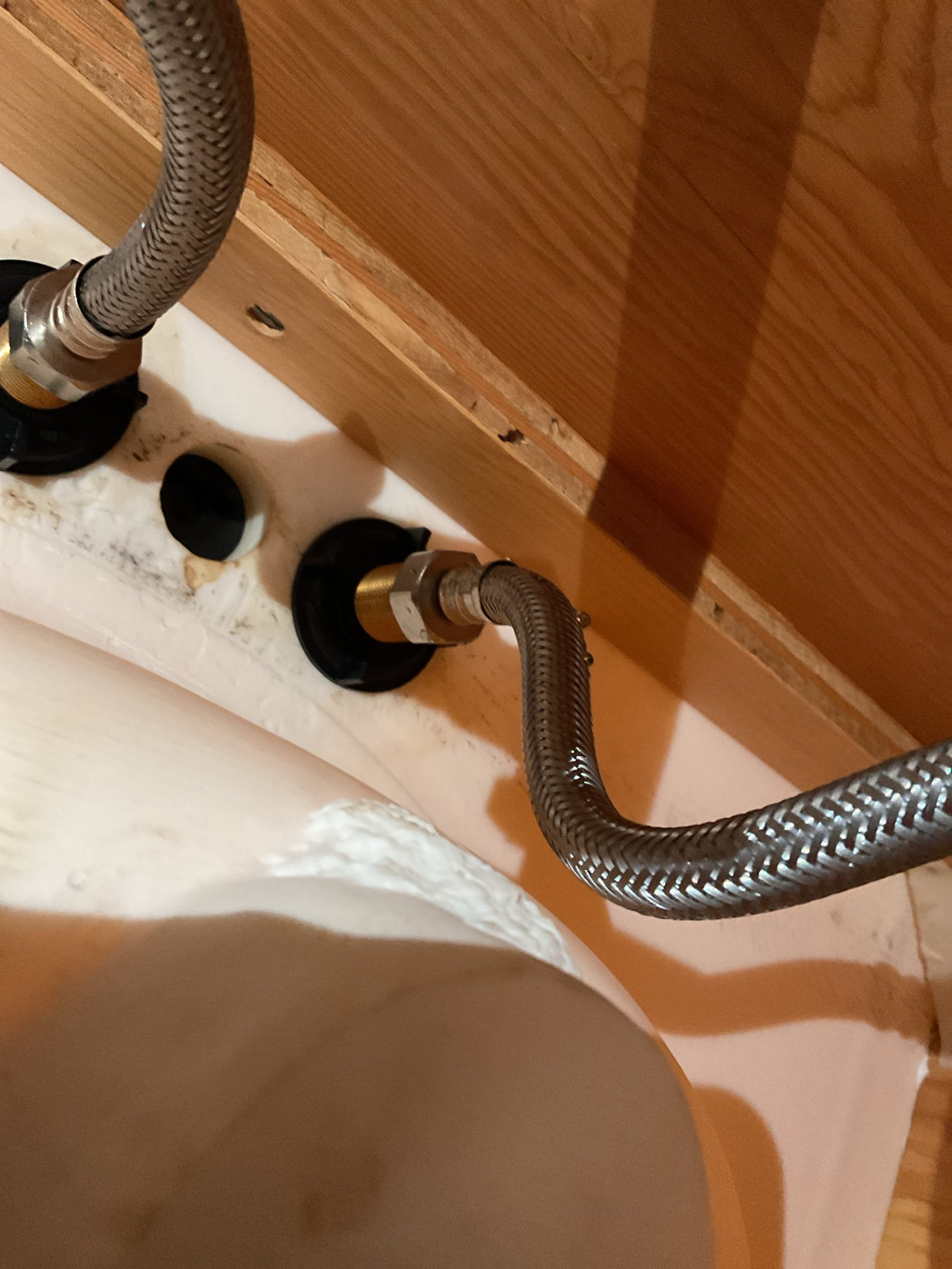 Upon arrival, the homeowner had the hot water side of the faucet shut off due to a leak. After opening the valve, water was found leaking heavily from the braided supply line, which had not been leaking at completion of the previous visit and had developed sometime afterward. The supply line was under excessive tension, causing gasket failure at both the top and bottom connections.
Water was shut off and the line was replaced with a new 20” braided supply line to provide a proper, relaxed connection to the fixture. The system was tested thoroughly, and no leaks were observed at this time. All work was under warranty and was free of charge.