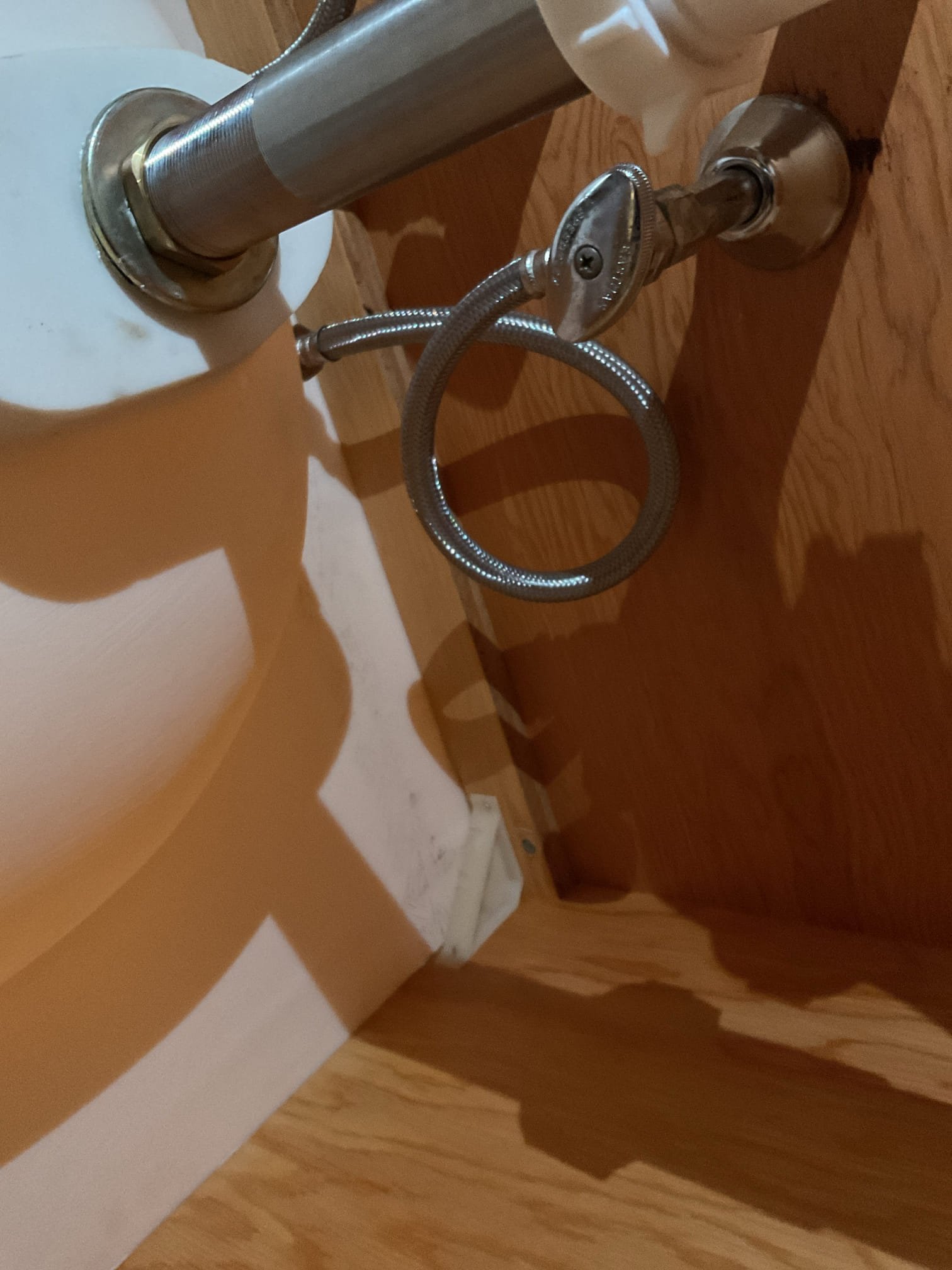 Upon arrival, the homeowner had the hot water side of the faucet shut off due to a leak. After opening the valve, water was found leaking heavily from the braided supply line, which had not been leaking at completion of the previous visit and had developed sometime afterward. The supply line was under excessive tension, causing gasket failure at both the top and bottom connections.
Water was shut off and the line was replaced with a new 20” braided supply line to provide a proper, relaxed connection to the fixture. The system was tested thoroughly, and no leaks were observed at this time. All work was under warranty and was free of charge.