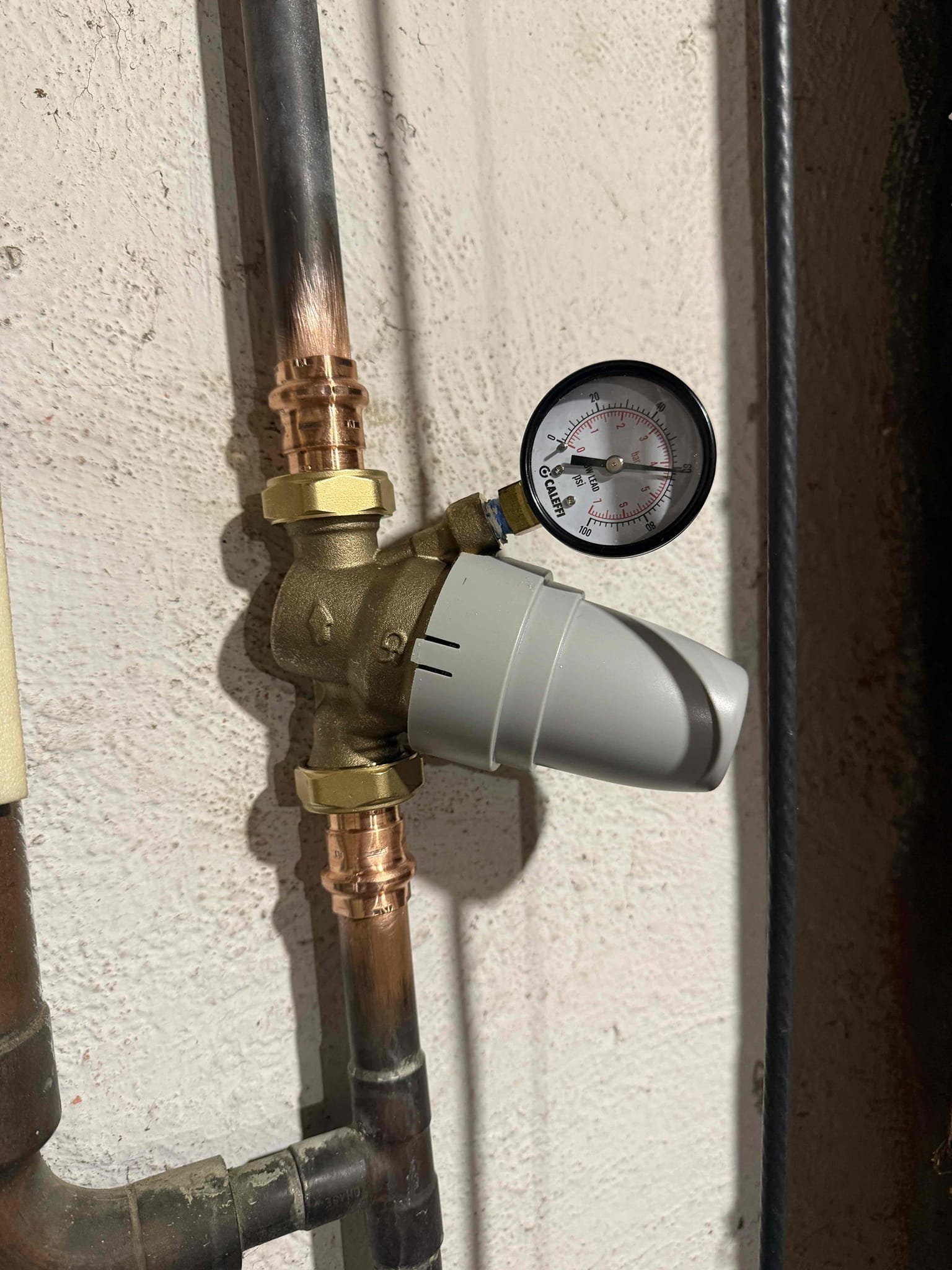 Upon arrival, the customer reported water leaking from the boiler. After inspection, the boiler’s automatic water feeder was found to be the source of the leak. The isolation shutoff valve required to drain the boiler for replacement was also severely corroded. With the customer’s approval, the failed water feeder and the corroded shutoff valve were removed and replaced. All connections were properly sealed and tested.

During the system inspection, the expansion tank serving the water heater was found to have failed. With authorization from the customer, the expansion tank was replaced and securely mounted to the wall, tying into the existing piping configuration.

Further testing revealed the domestic water pressure was excessively high, fluctuating between 85–90 psi. This indicated the need for a pressure-reducing valve to protect the plumbing and equipment. The customer approved installation, and a new pressure-reducing valve was installed on the incoming water main and adjusted to