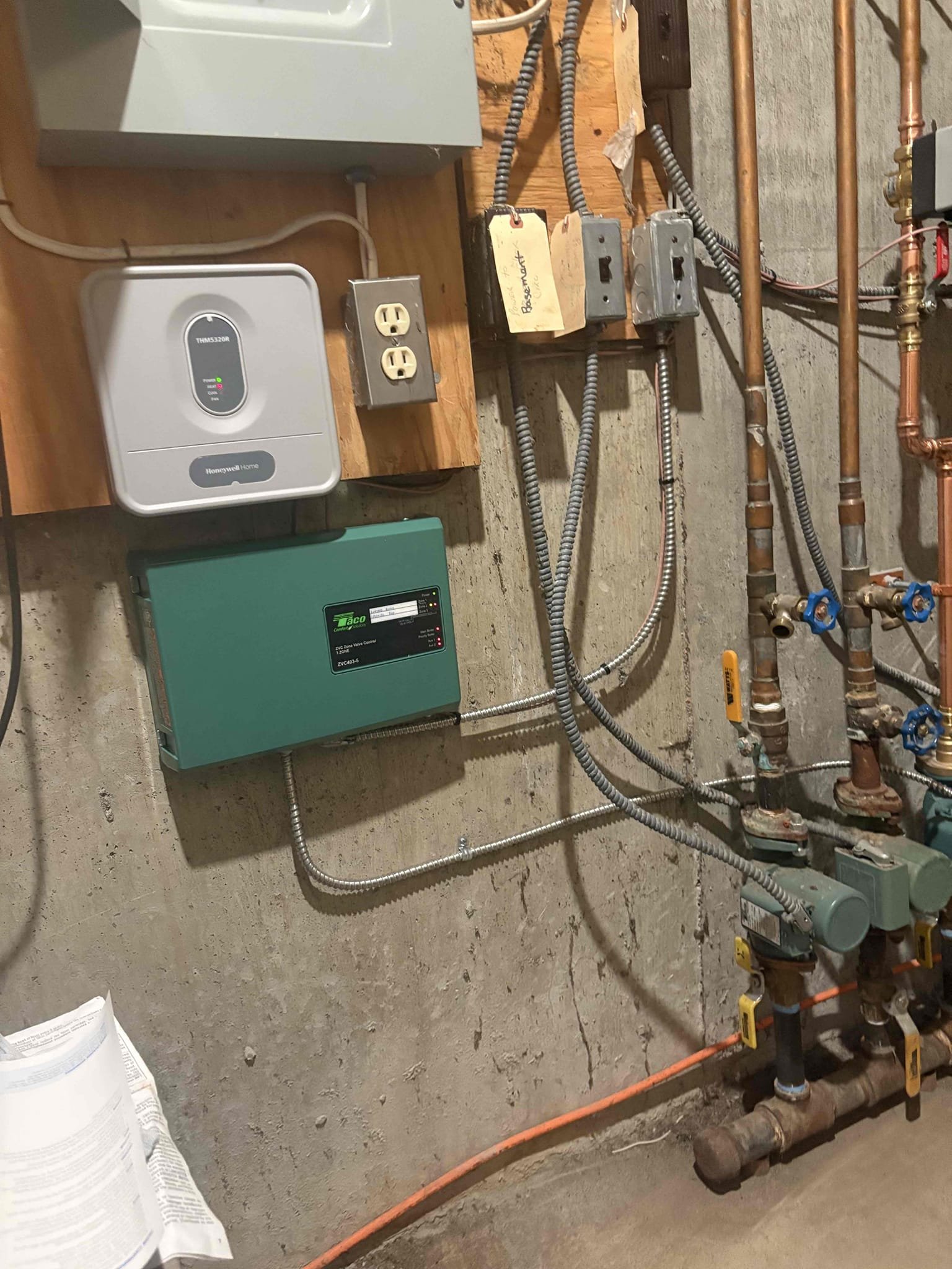 Installed a wireless thermostat and two zone valves to allow the upstairs bedroom to operate independently from the living room zone. Replaced the circulator serving both zones and installed new piping, shut-off valves, and a drain. Installed a new zone-valve relay board and connected the thermostats, circulator, and both zone valves. Purged air from the system and confirmed proper circulation of hot water. Tested and verified proper communication between the control board and both thermostats. Set both thermostats to 65°F.

David also reported that the toe-kick heater in the master bathroom was not running. During inspection, I found no power being supplied to the unit. I tested the Romex cable feeding the heater and detected no voltage. I confirmed all breakers in the panel are on and none of them are tripped. I also tested each light switch and the GFCI outlet in the bathroom and confirmed they were functioning properly, but power was still not present on the heater circuit. I revie