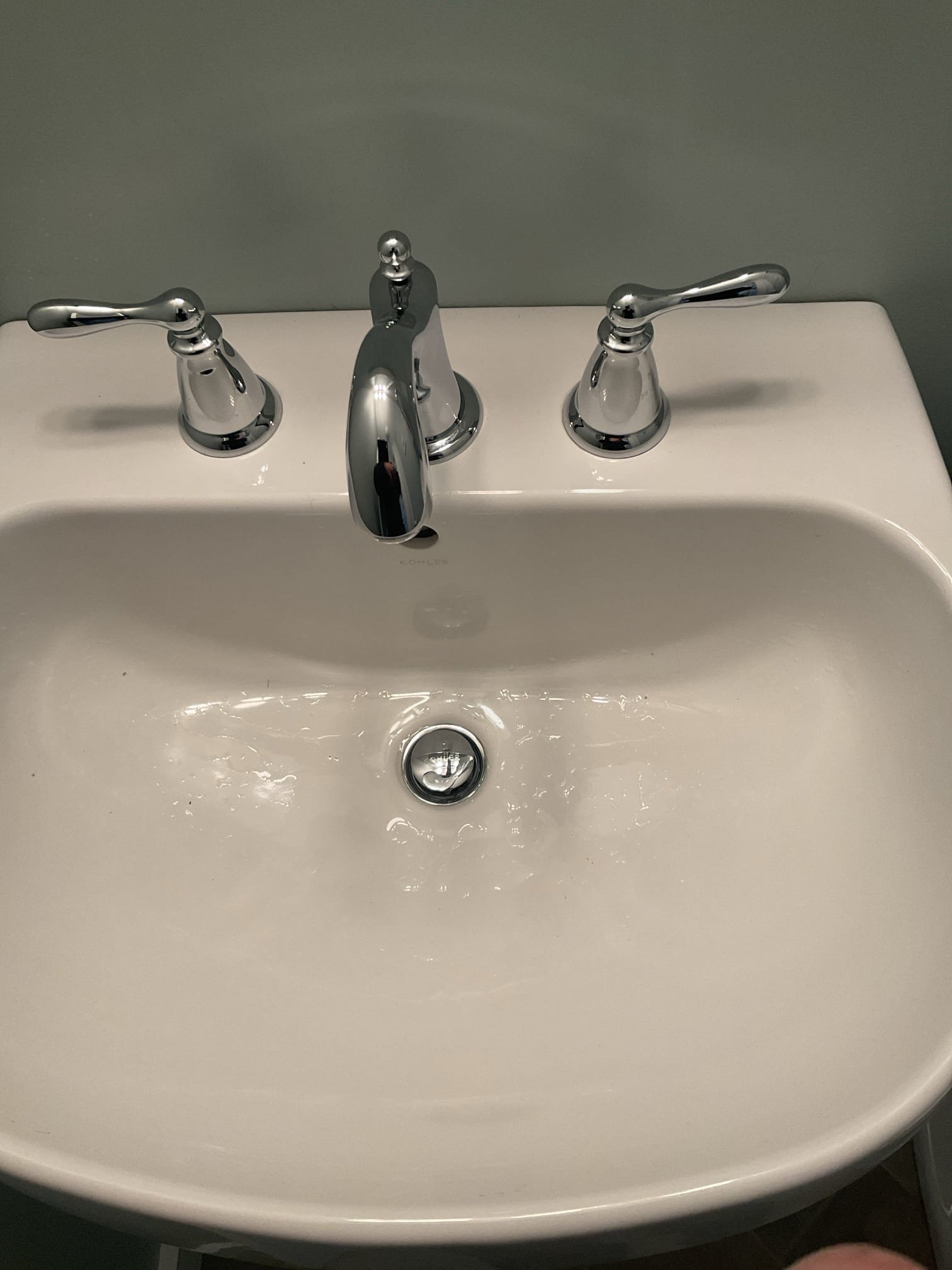 Lavatory Pop-Up Assembly Replacement – Upstairs Bathroom:
The lavatory pop-up assembly was found to be heavily corroded around the drain base and cap. We recommended replacement to ensure a proper seal, prevent leaks, and restore reliable drainage. Water was shut off and the drainage disconnected, then the pedestal top was removed to complete the repair. The existing pop-up was removed and surfaces were cleaned thoroughly. A new pop-up assembly was installed using plumber’s putty and thread sealant, and fittings were tightened securely. The trap was partially pre-assembled due to limited space, and the pedestal top was reset with new wall anchors and a bead of caulk at the base. The p-trap was reassembled and new braided supply lines were installed. The system was tested with water on, confirming proper operation with no leaks present at this time.

Lavatory Replacement Recommendation – Downstairs Bathroom:
The downstairs bathroom pop-up assembly was not functioning, preventing proper 