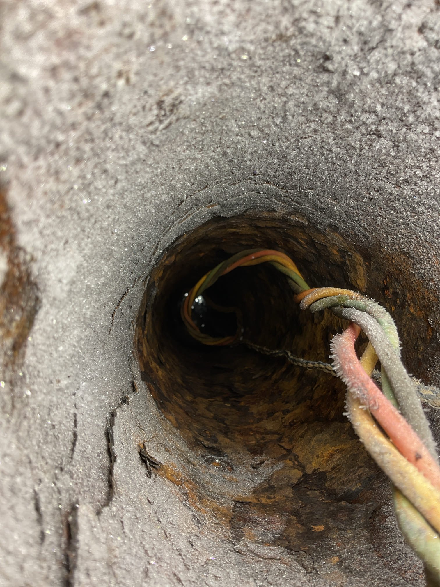 We came out to the property for a no-water situation and found that the well pump was drawing high but stable amperage, indicating that the motor was running but water was not moving. Based on these findings, we determined that the issue was most likely a blockage or frozen section within the water line rather than a pump failure. The customer planned to place heaters under the house to thaw the line and will inform us of the results. If water does not return after thawing efforts, replacement of the well pump will be necessary.