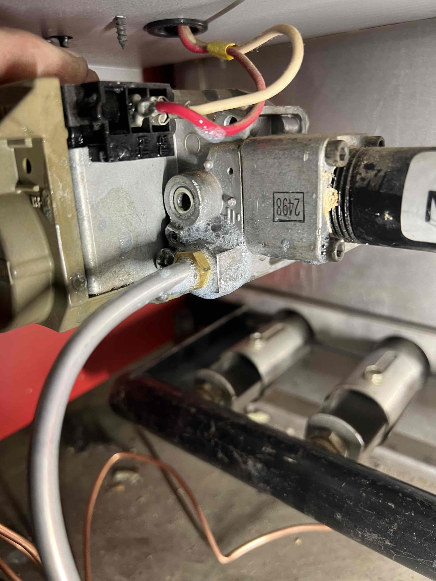 Arrived onsite to diagnose a no-heat issue on a propane boiler. We had performed an annual tune-up on Friday, 12/6/25, during which we provided an estimate to replace a worn thermocouple that the customer declined. They replaced the thermocouple themselves and experienced intermittent issues until the system eventually stopped producing heat. They also reported a gas odor when they contacted me on Sunday, 12/7/25, and I advised them to shut off the gas immediately.

Upon arrival, I bubble-tested the pilot line and confirmed it was leaking. I advised the customer that all gas-related work should be performed by a qualified gas professional due to the associated safety risks. I replaced the pilot line and found that the thermocouple holder was melted, causing the thermocouple to be stuck in place. After reassembly, the pilot would not remain lit. Due to the damaged thermocouple holder, I recommend replacing the entire pilot assembly and thermocouple.

Additionally, the expansion tank is 