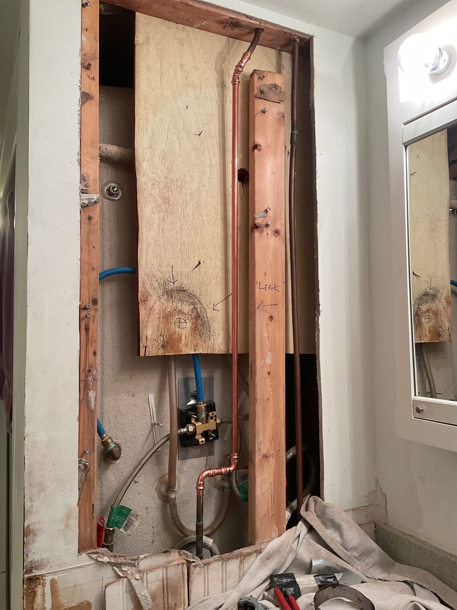 Water was leaking from behind the shower and the toilet had failed internals. To remedy these issues we cut the Sheetrock behind the shower to find the source of the leak and replaced the toilet. We found a pin hole leak in corroded pipe which we cut out and installed new copper pipe and installed the new toilet. Everything tested for leaks with non found at this time

12/11
Returned to install toilet seat